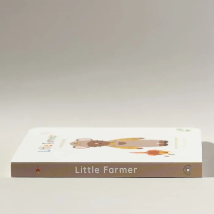 Children's book titled 'Little Farmer' with a cartoon illustration of a pink pig wearing yellow overalls and a brown horse on the cover.