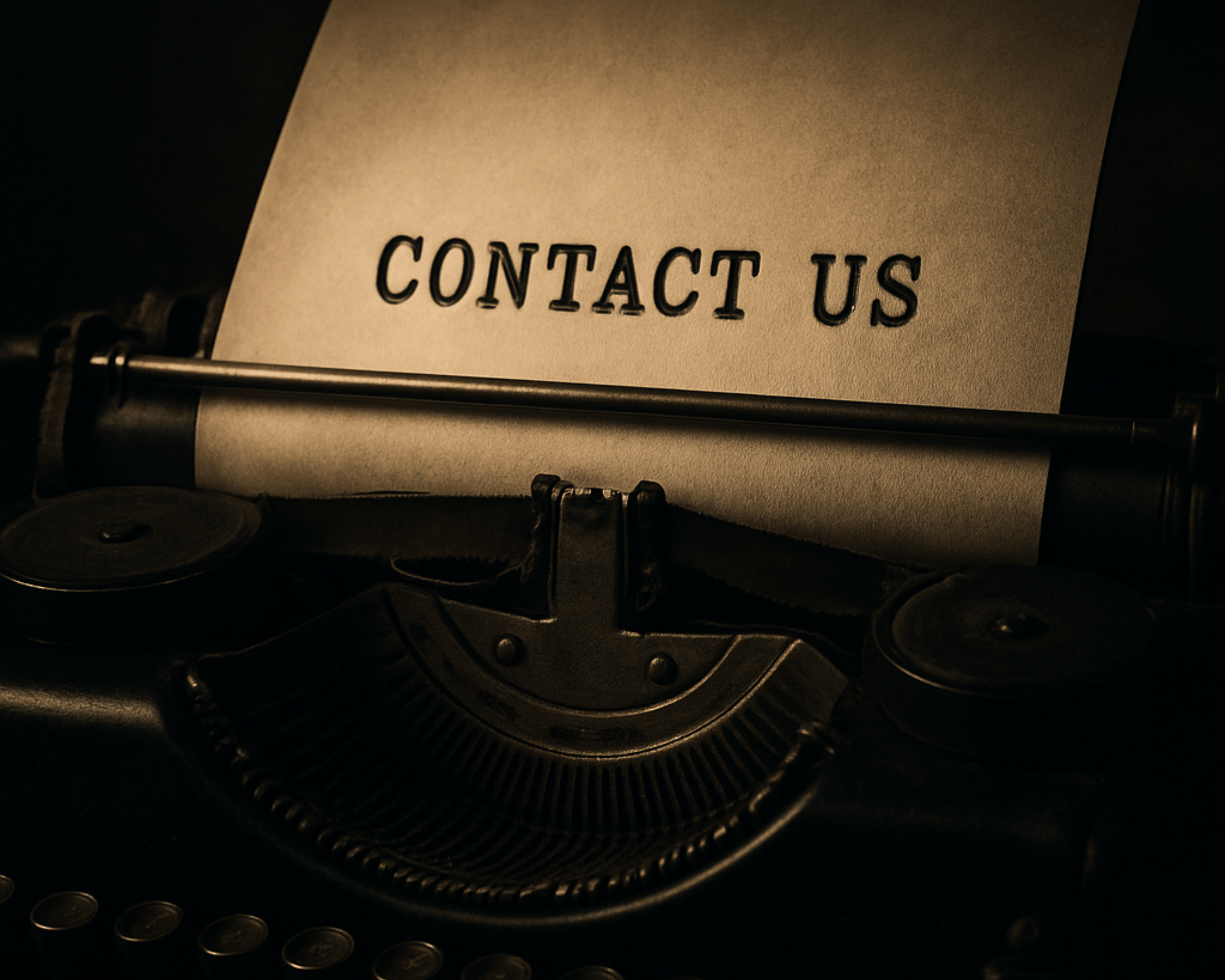 Image of a typewriter with the words Contact Us on the paper