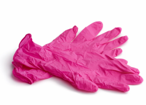 Pair of pink rubber gloves on white background.