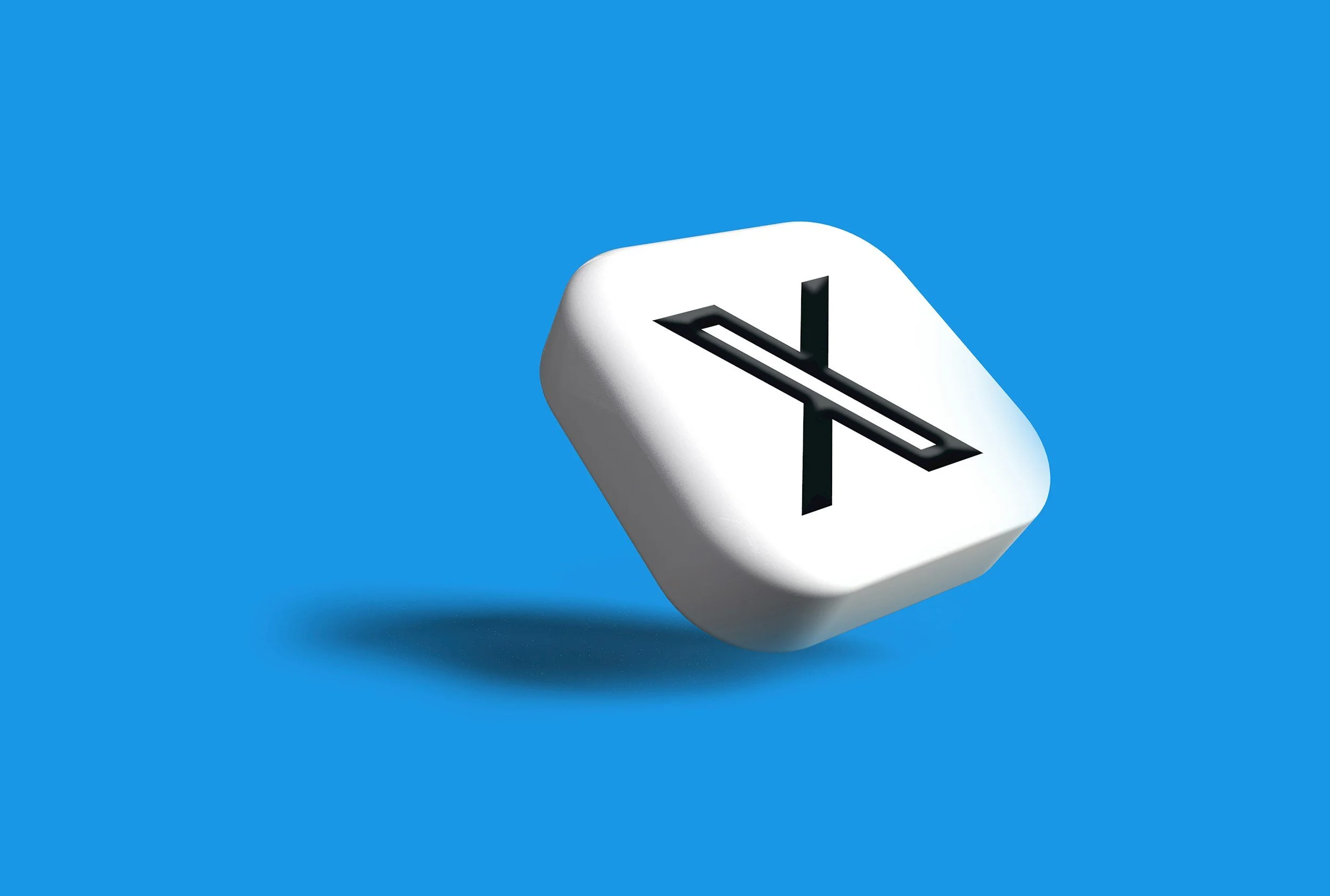 A white button with a downward-pointing arrow and an 'X' symbol on it, set against a blue background.
