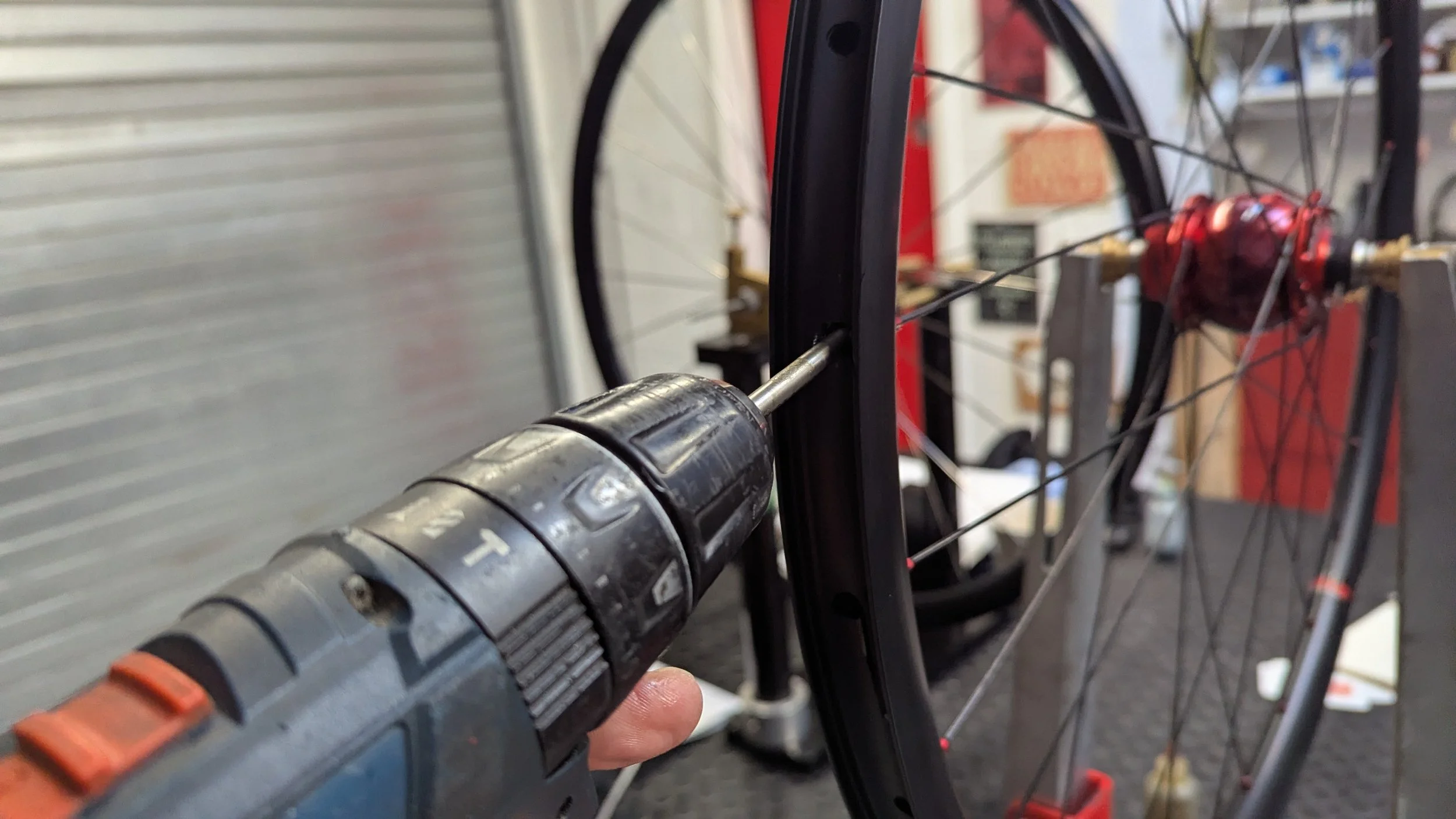 Bringing a custom wheel up to tension with a nipple drill