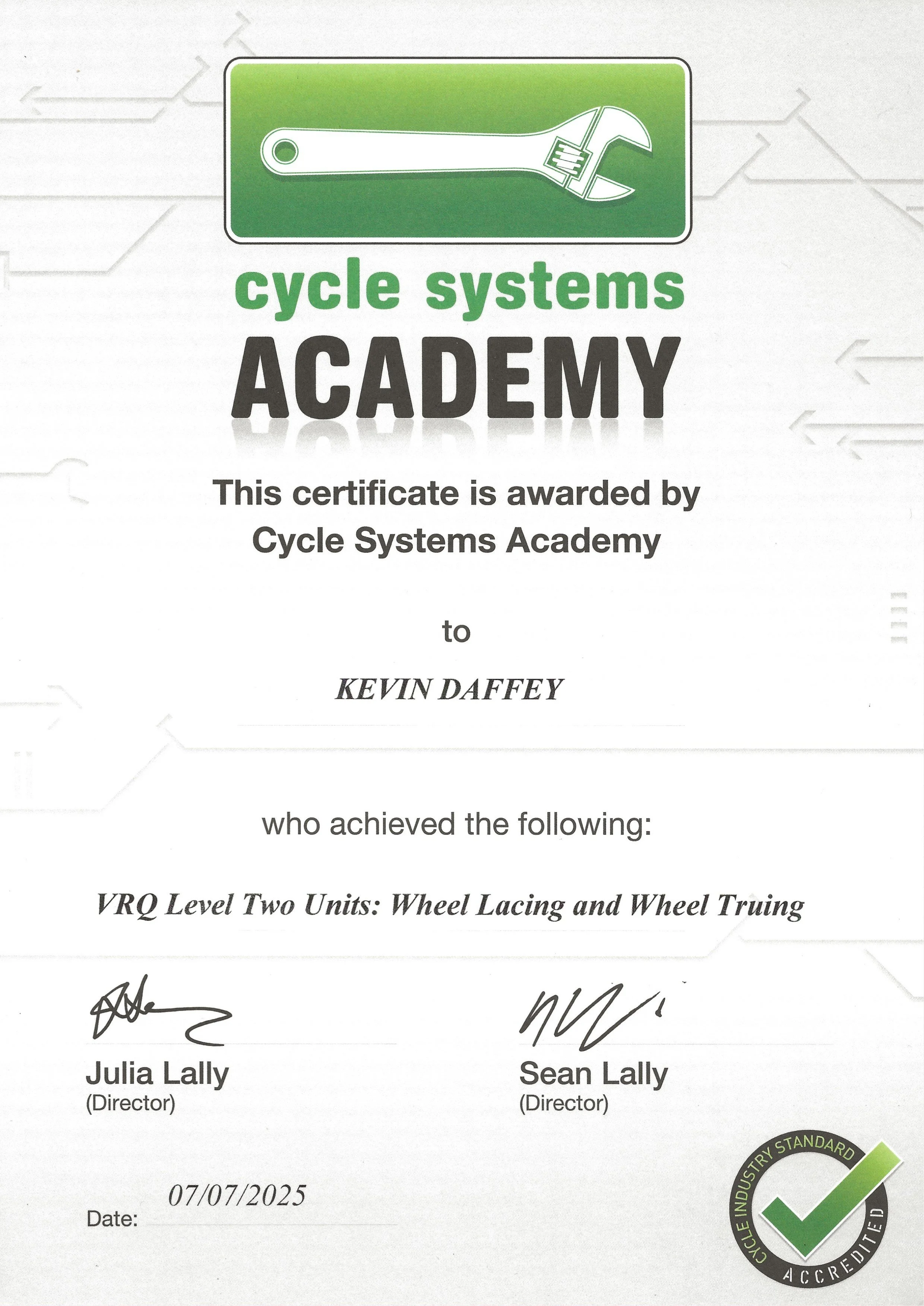 Certificate awarded by Cycle Systems Academy to Kevin Daffey for VRQ Level Two Units: Wheel Lacing and Wheel Truing, signed by Julia Lally and Sean Lally, dated 07/07/2025, with a green and black certification badge in the bottom right corner.