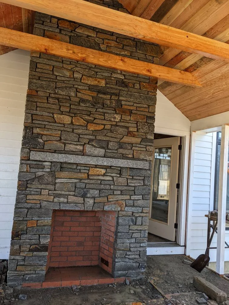 fireplace built in screened porch veneered with weathered granite 