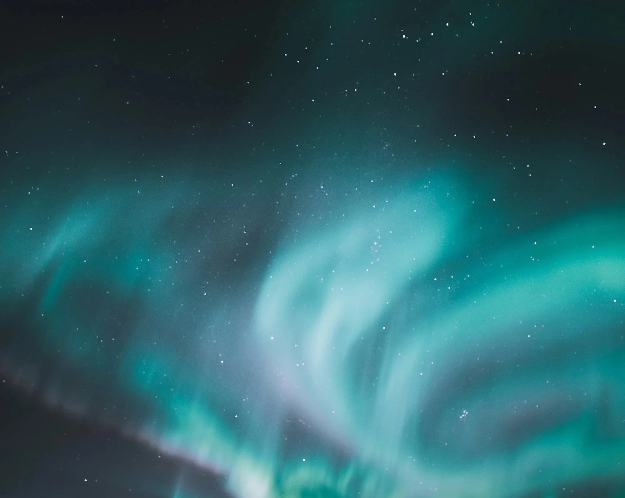 Northern lights or aurora borealis in the night sky with stars.