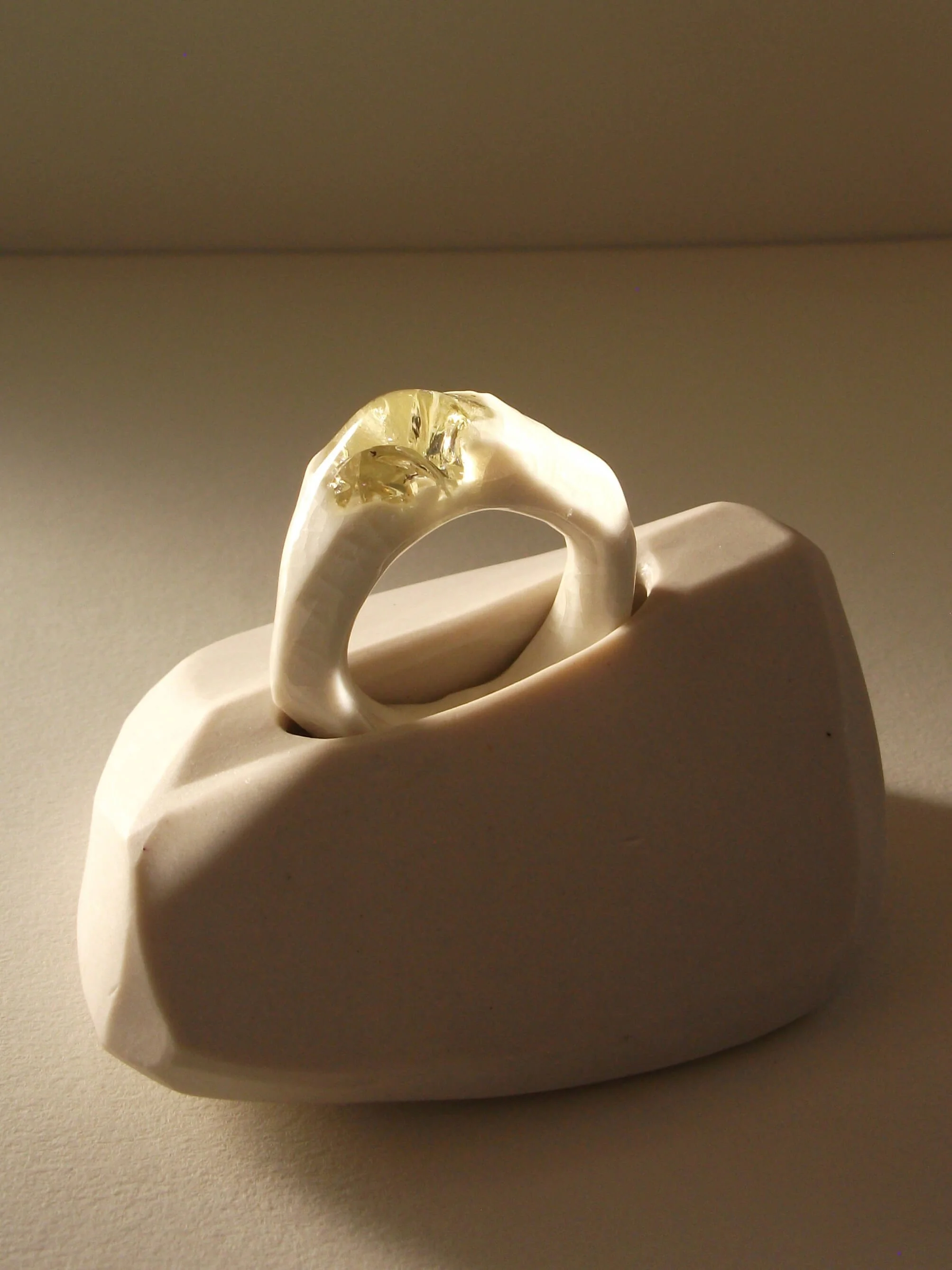Bone-white porcelain ring with crackle surface and soft champagne glass jewel