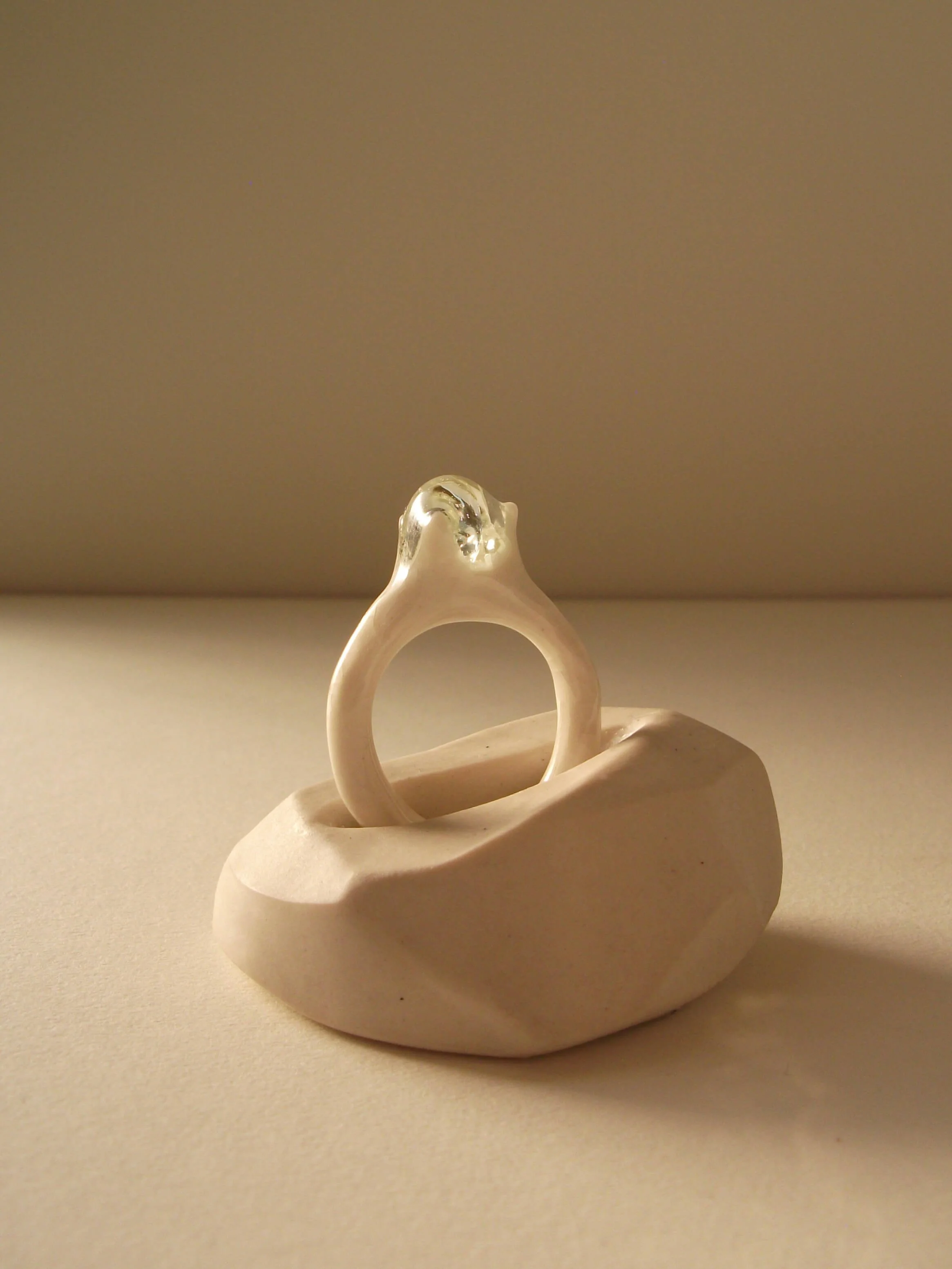 Close-up of glass droplet on delicate bone-white porcelain ring