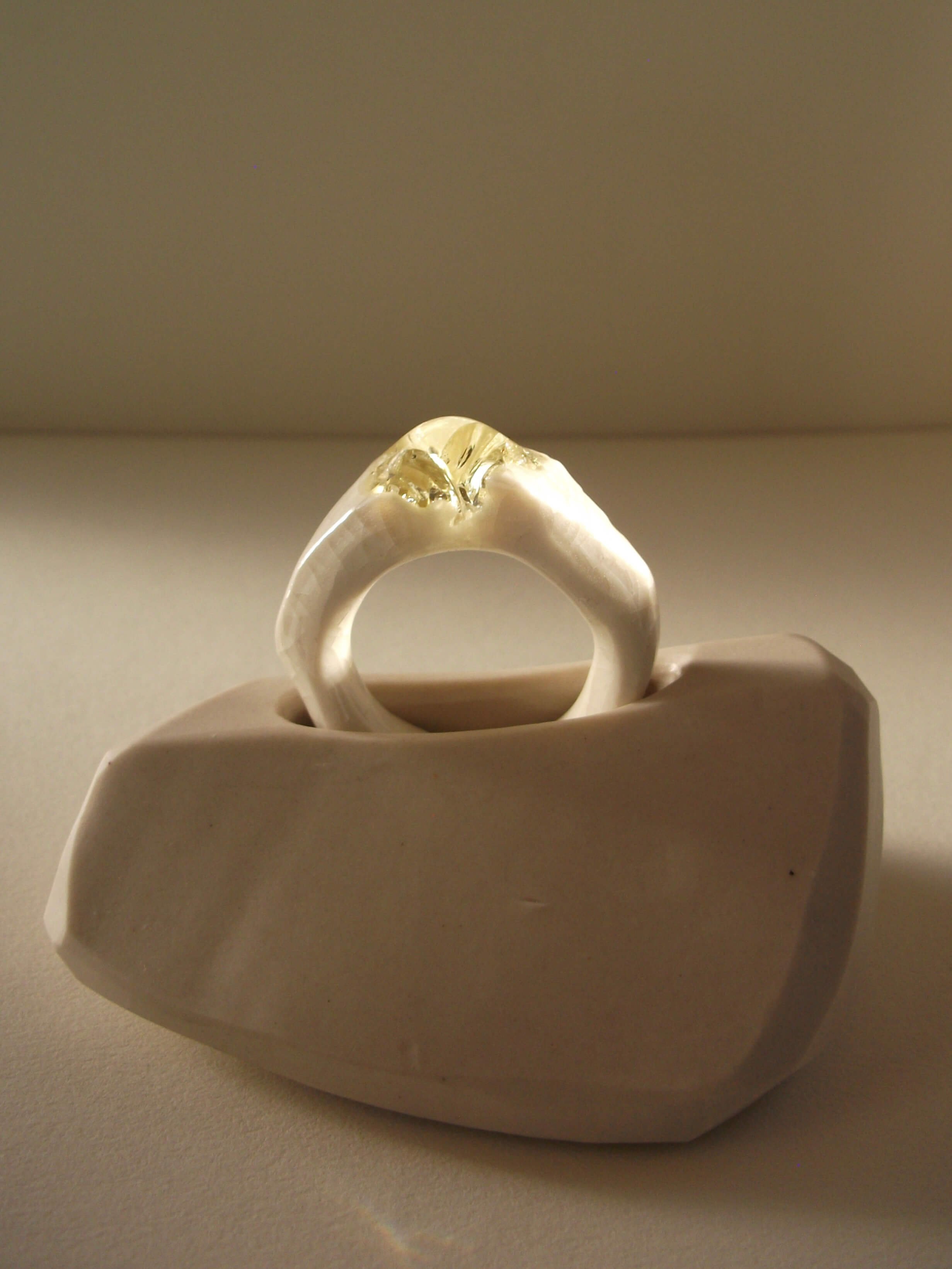 Bone-white porcelain ring with crackle surface and soft champagne glass jewel