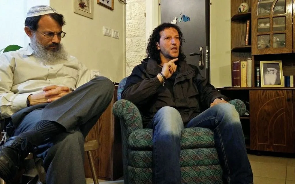 In a settler’s living room, a Palestinian reaches out