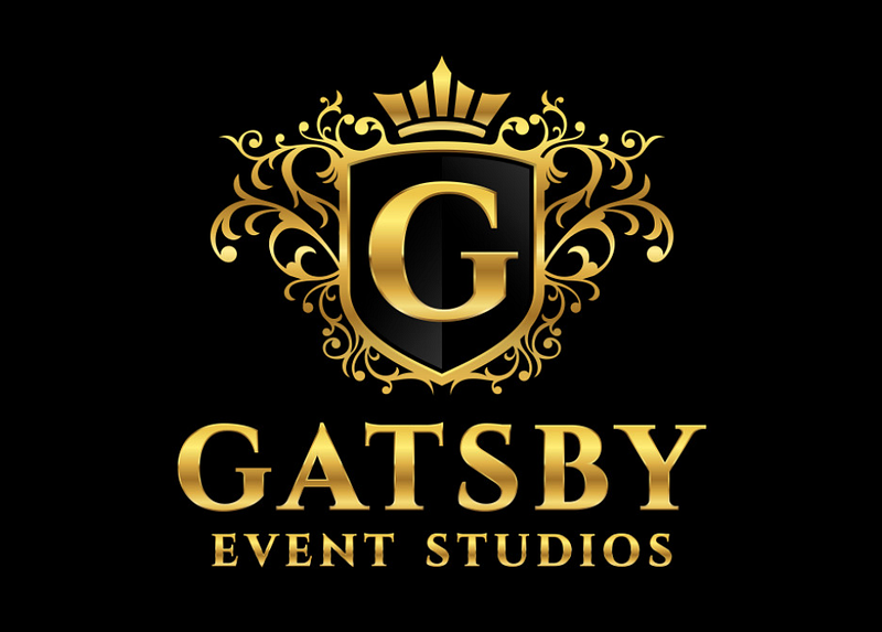 A gold and black logo for Gatsby Event Studios featuring a crest with the letter G, ornate swirls, and a crown, with the text 'Gatsby Event Studios' underneath.