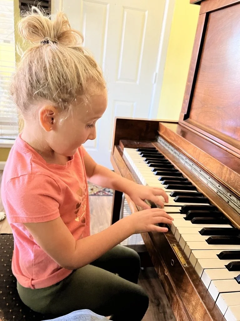 Chris’s daughter exploring the piano keys