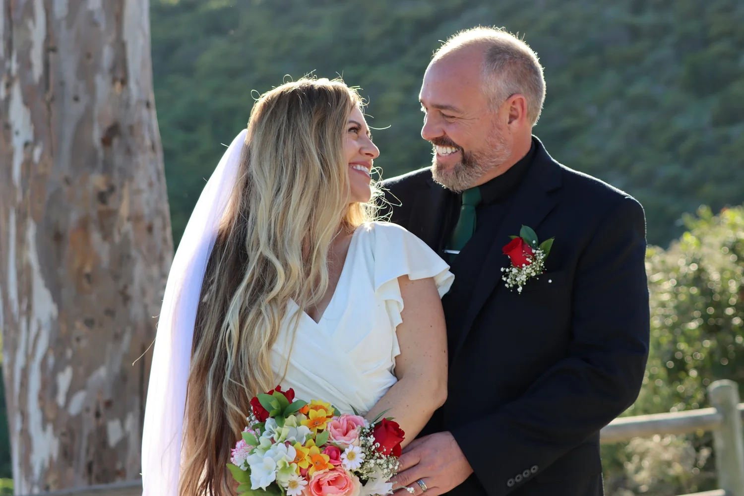 A bride and groom smiling at each other