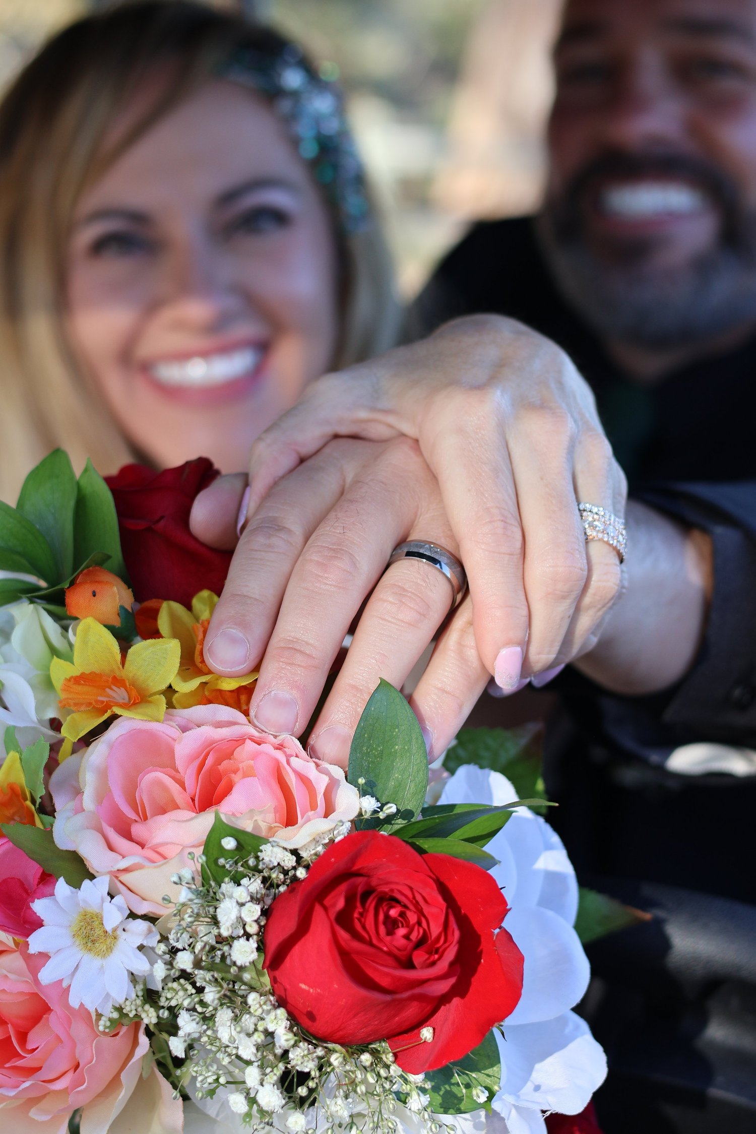 Wedding rings and a colorful bouquet