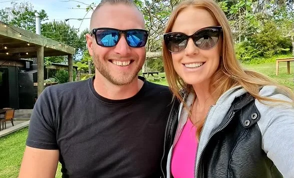 James & Michelle wearing sunglasses outdoors in a park or garden.