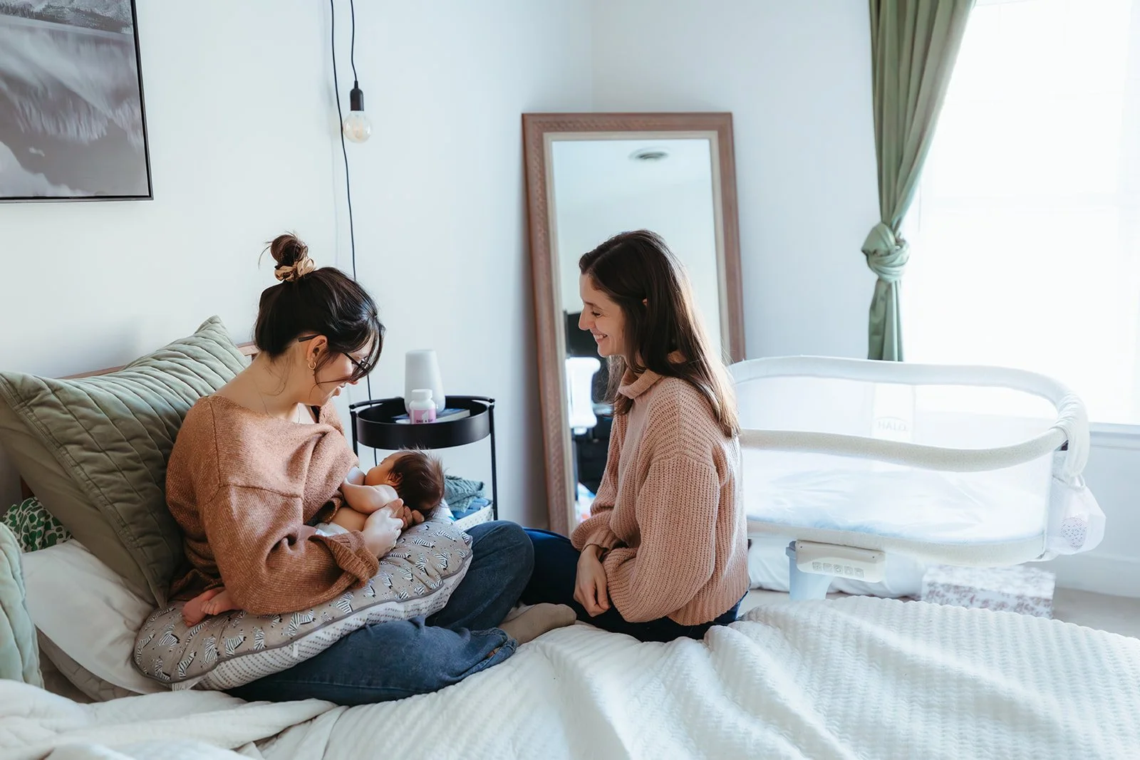 fourth trimester mom feeding her baby with support of a doula