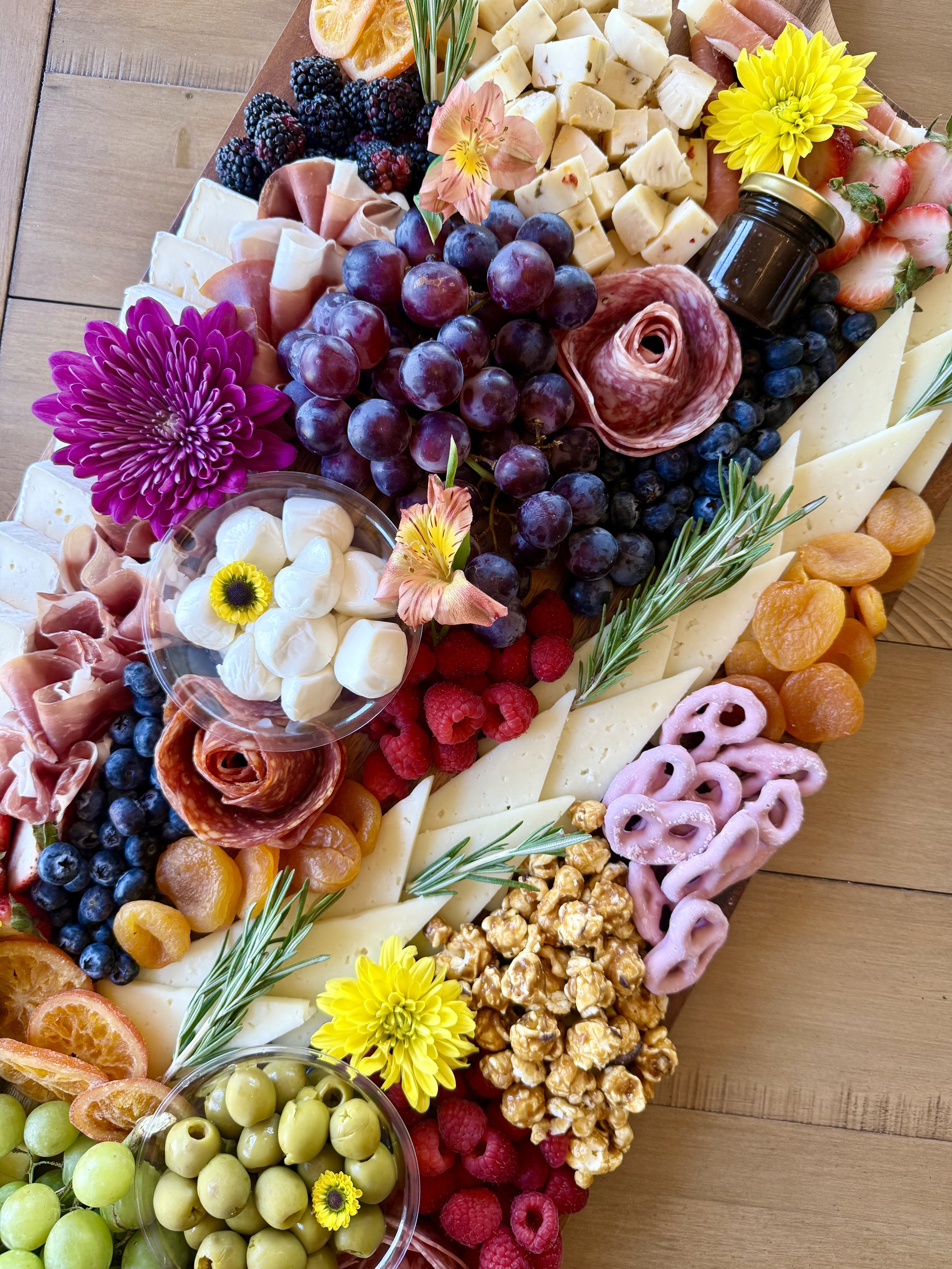 charcuterie-board-detail-grapes-salami-rose-pretzels.jpeg