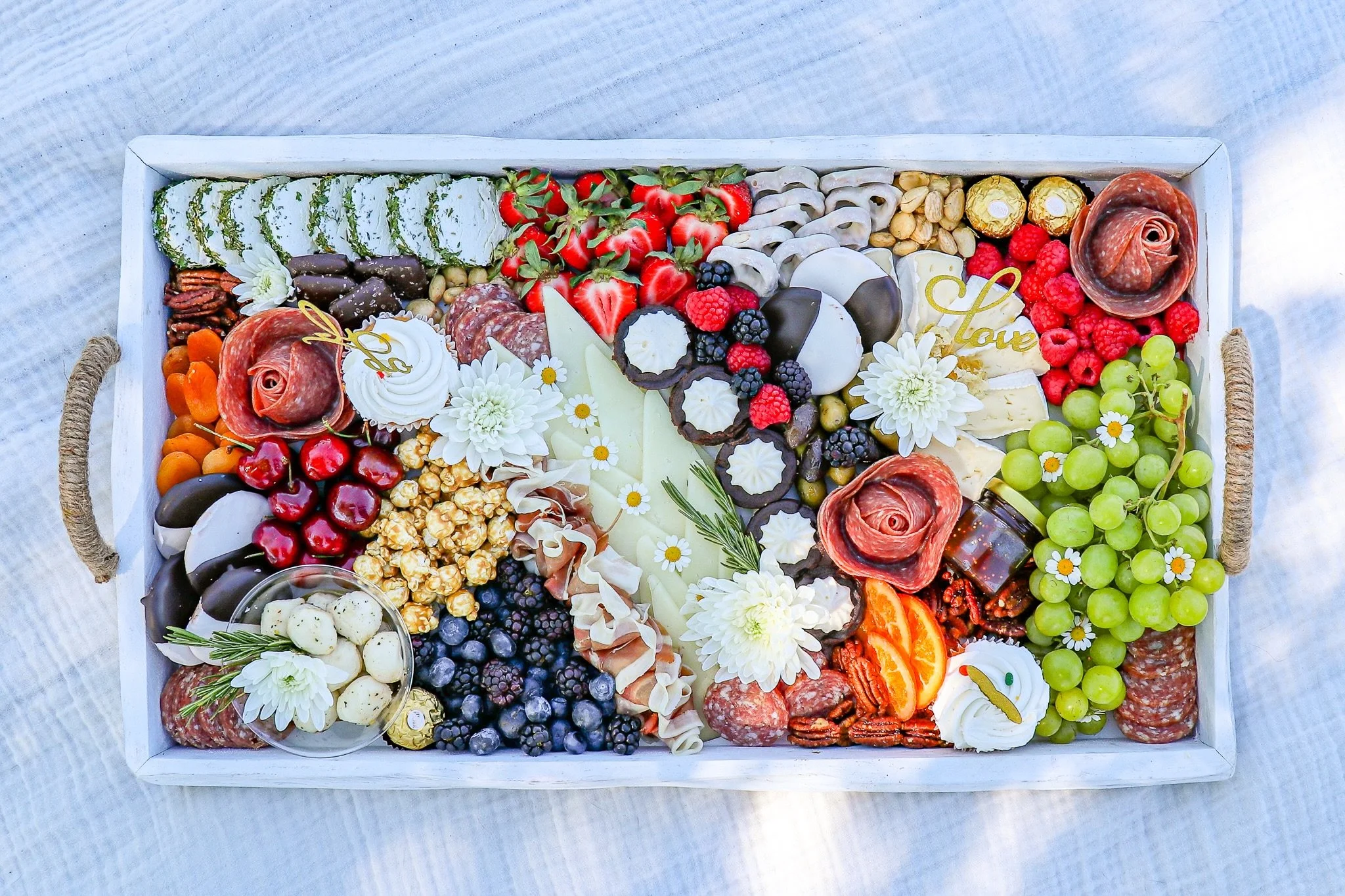 Bridal shower styling. Tray, florals, and toppers curated to the event.