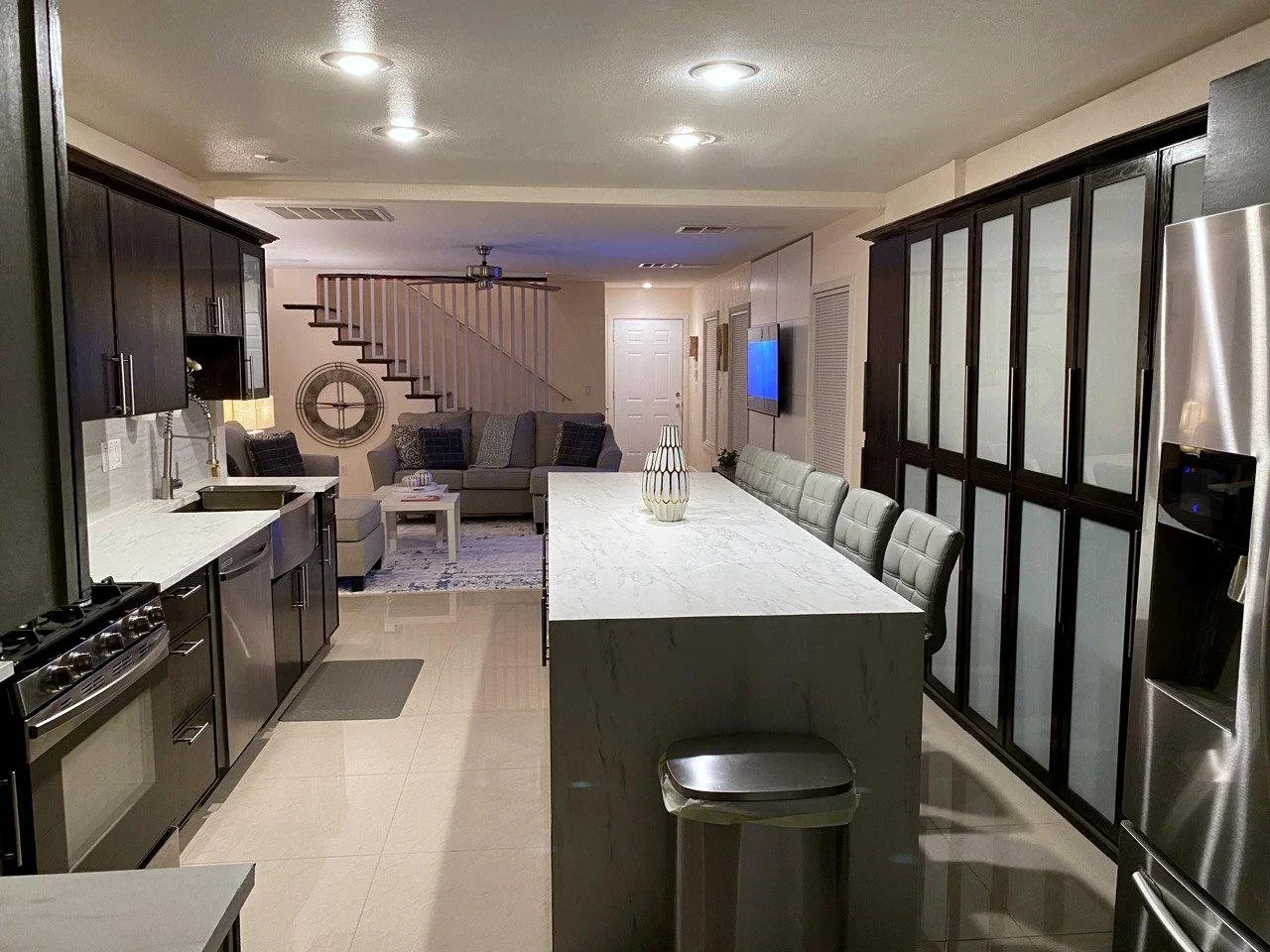 a remodeled kitchen island with smooth marble decor, professionally installed cabinetry, and smooth tile