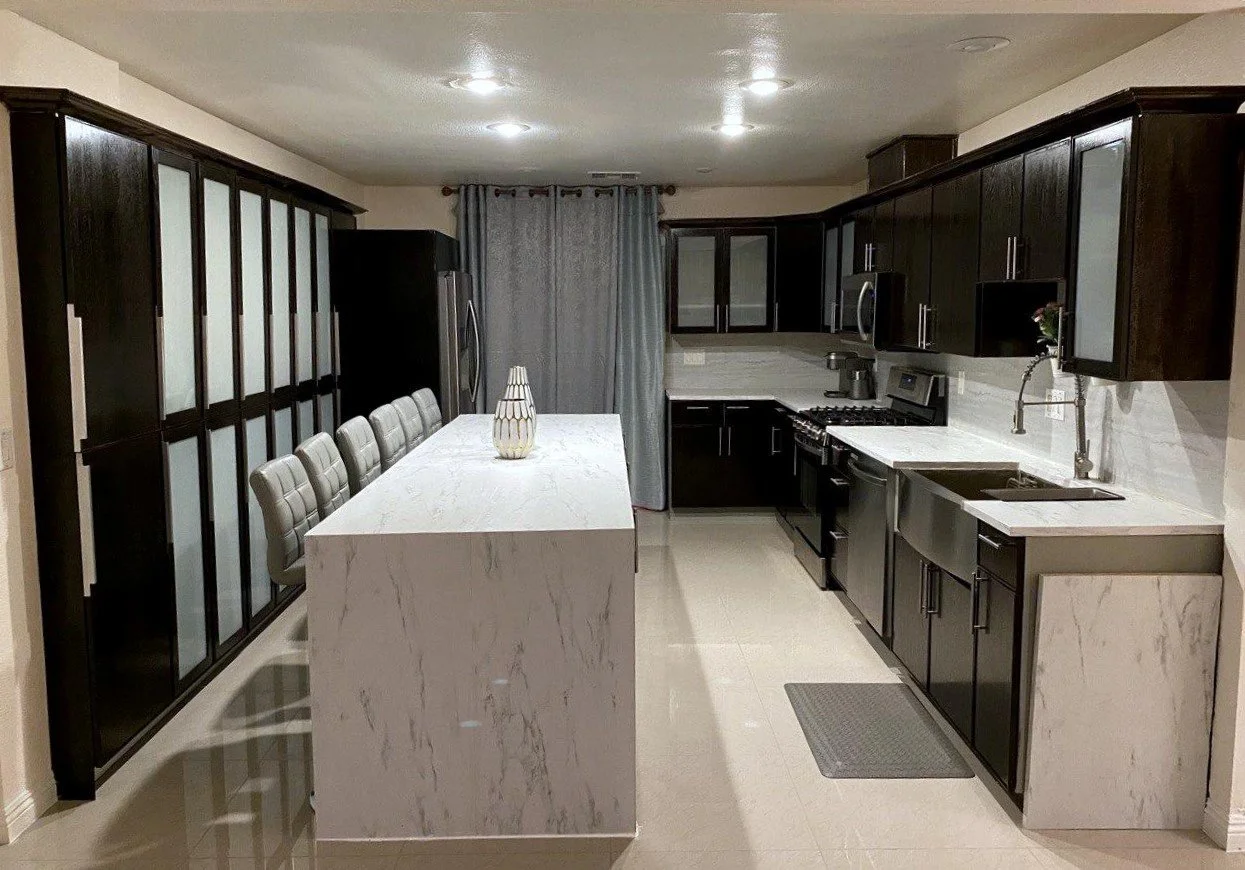 a remodeled kitchen island with smooth marble decor, professionally installed cabinetry, and smooth tile