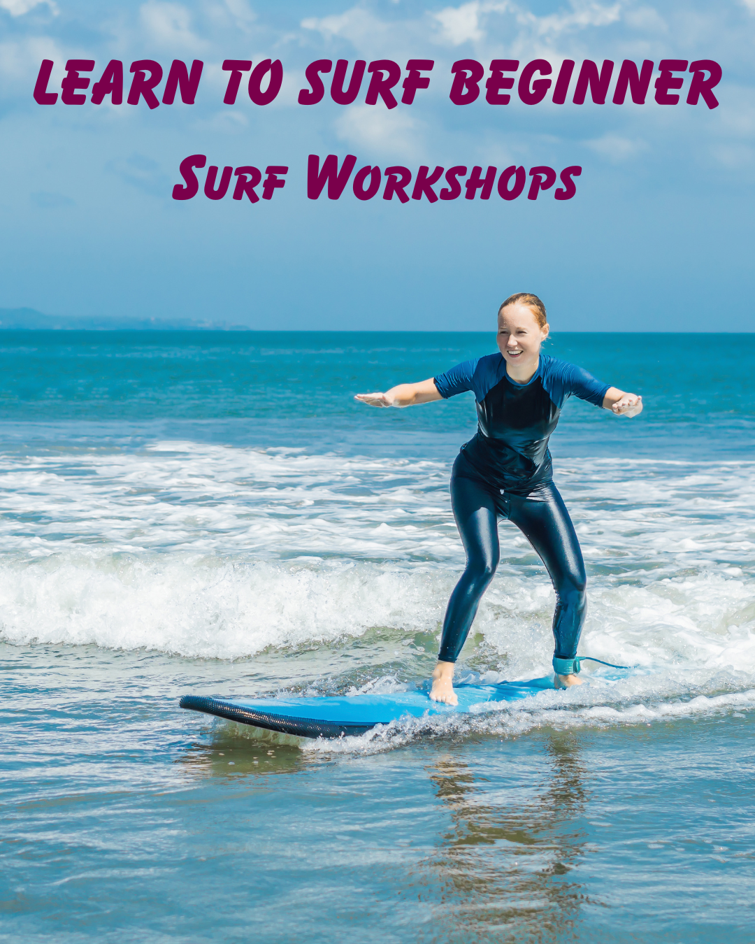 A woman surfing on a blue surfboard in the ocean, smiling, wearing a blue rash guard and shiny leggings, with blue sky and clouds in the background.
