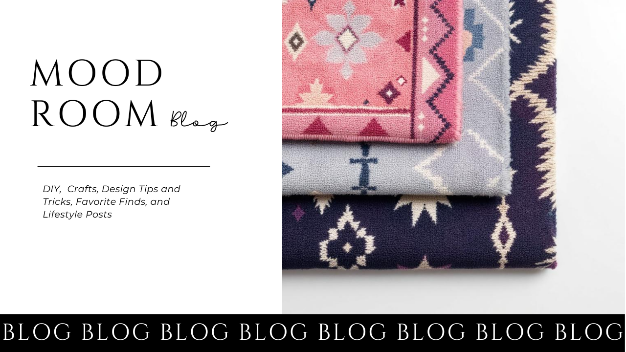 A blog header for Mood Room Blog featuring folded decorative rugs with geometric patterns in shades of pink, gray, and navy, and the blog title in black and script fonts.