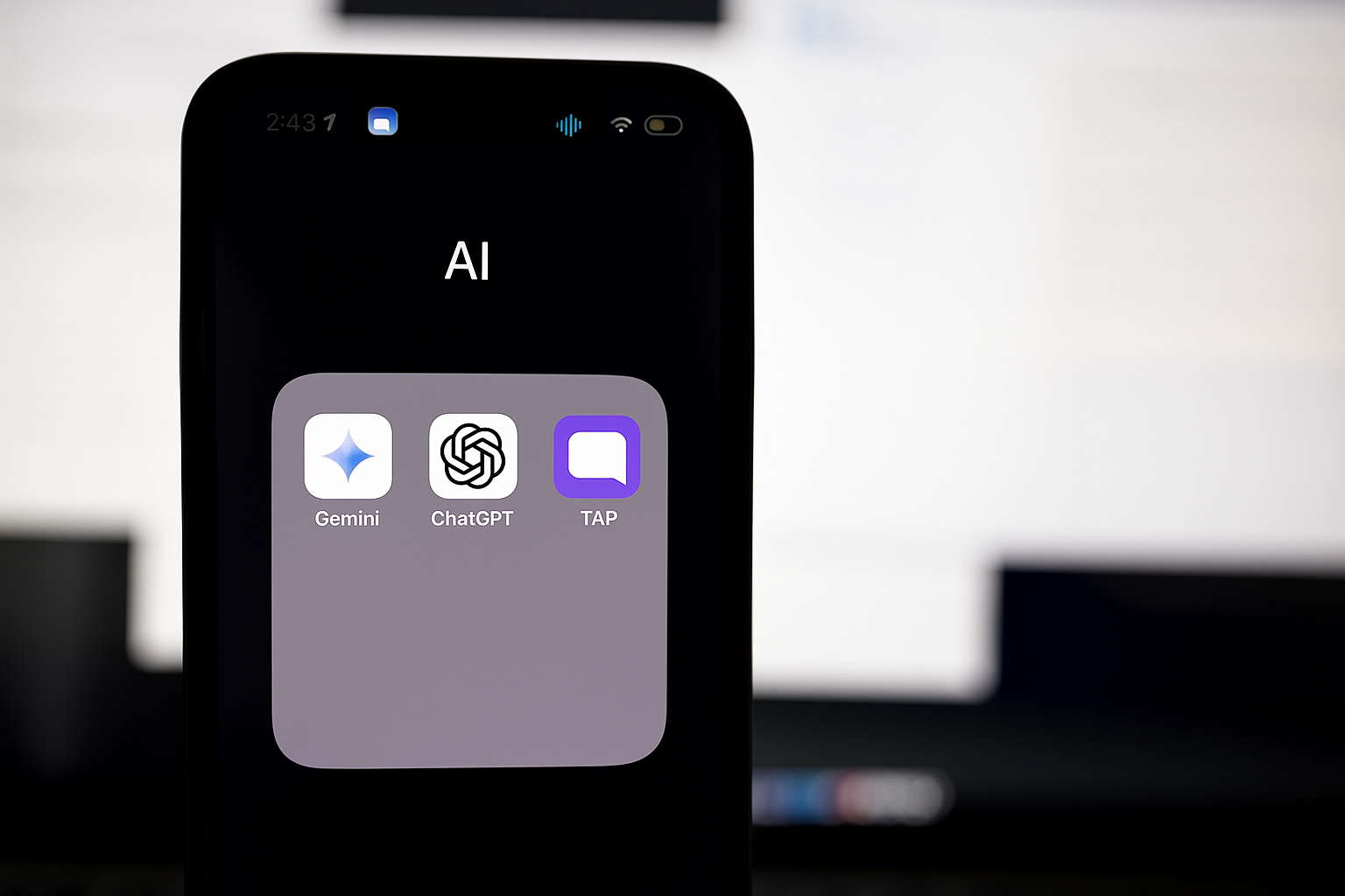 Smartphone screen showing an AI folder with Gemini, ChatGPT, and TAP app icons.