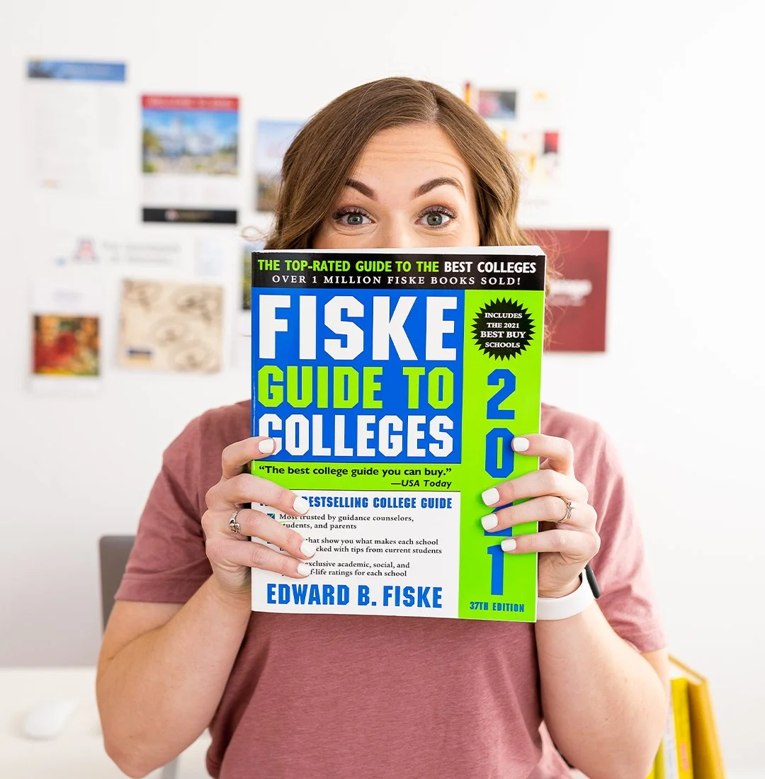 Carly Gieszl holds up the Fiske Guide to Colleges book