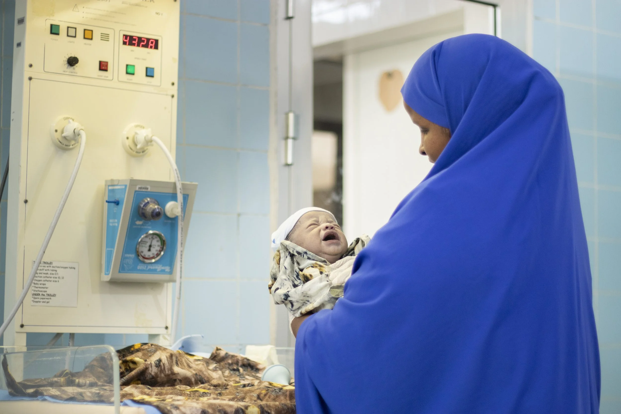 nurse with newborn.jpeg