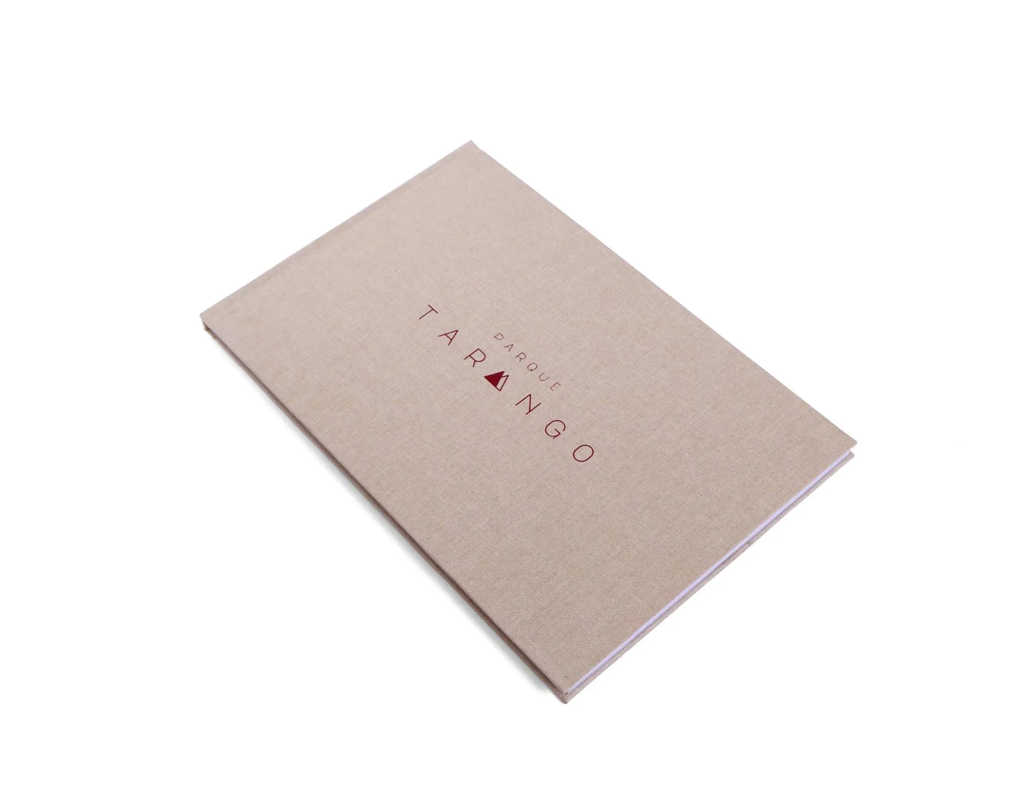 A closed beige booklet with the words 'Parque Tarango' printed on the cover in red.