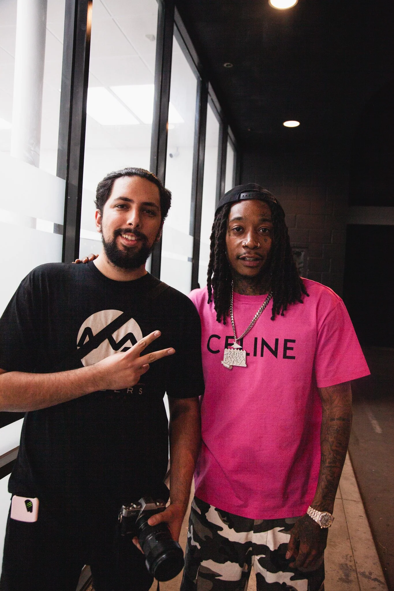 Wiz Khalifa and Gregorioux Taking a picure post BTS shoot of him on the On Track Podcast and Collab Track with DJ Holiday Season at MVA studio.