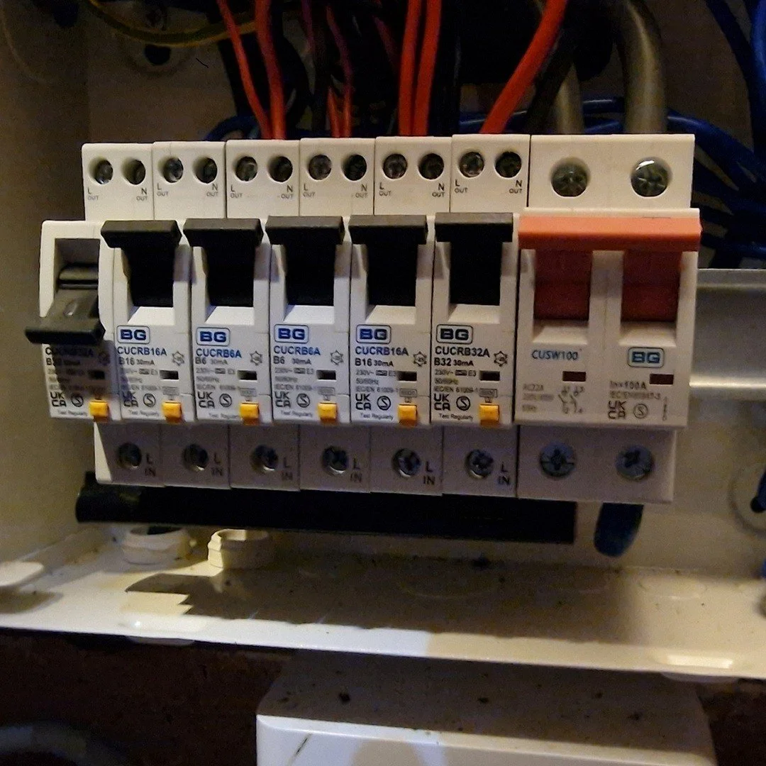 Electrical circuit breaker panel with multiple circuit breakers and wiring.