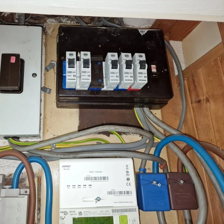 old asbestos consumer unit  with switch and 25mm wire