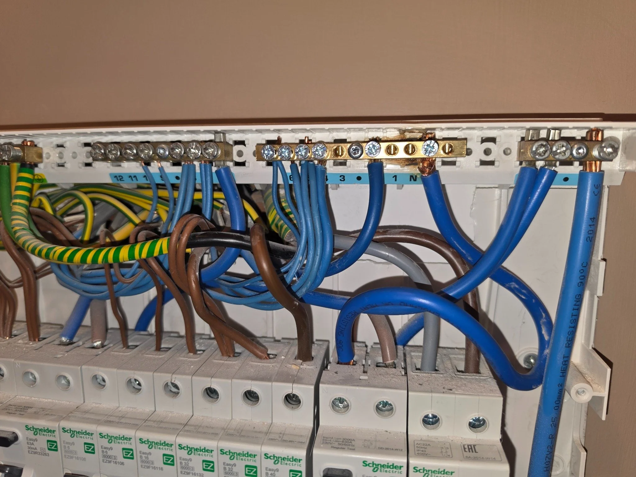 4. Repair stage: replacement neutral bar and renewed wiring. Earlier heat marking remains visible on the support behind it.