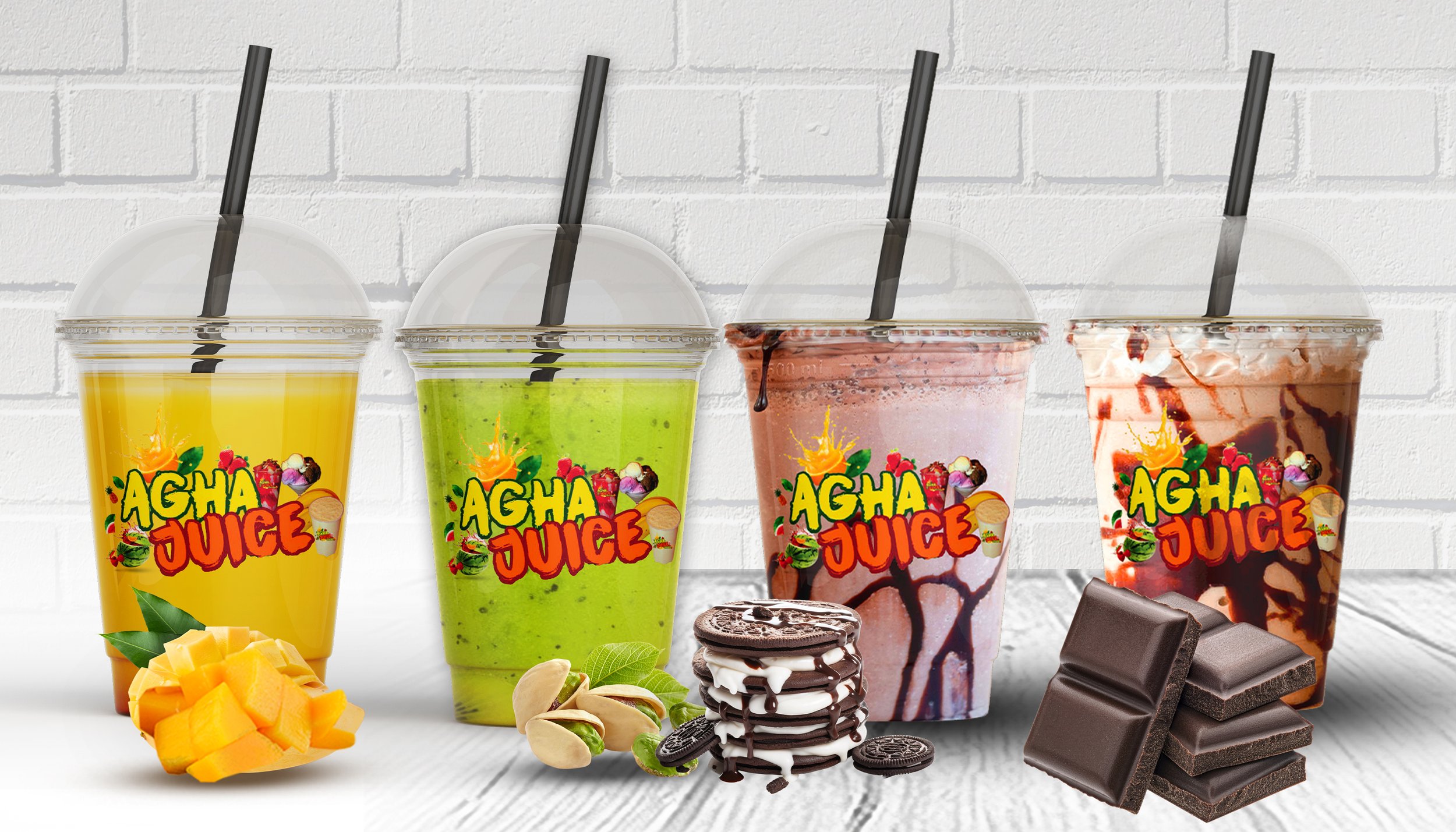 Four colorful Agha Juice drinks with toppings and chocolate, placed on a white wooden surface against a white brick wall.