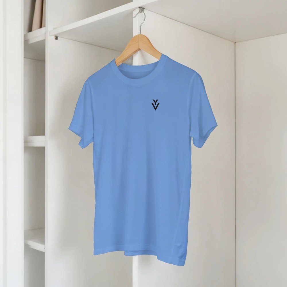 Light blue T-shirt hanging on a wood hanger inside a white closet, with a small black logo on the chest that shows a V and a check mark.