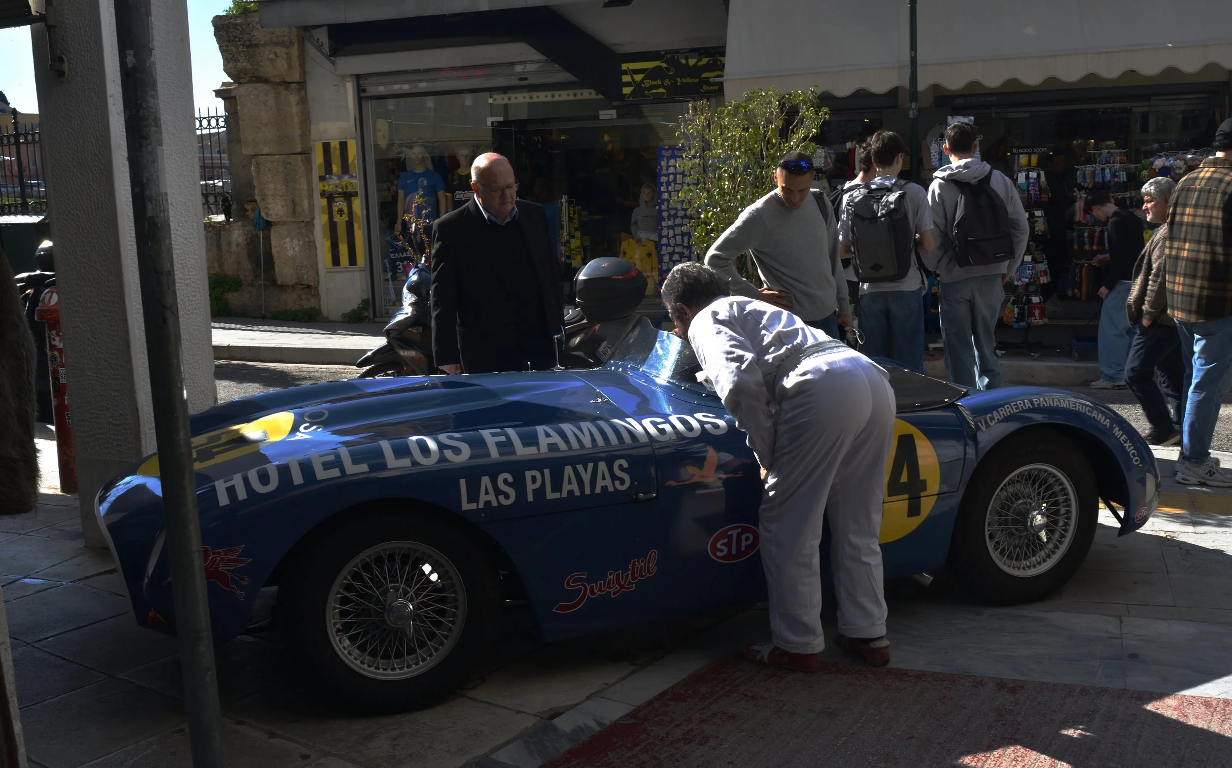 driver inspecting race car driver