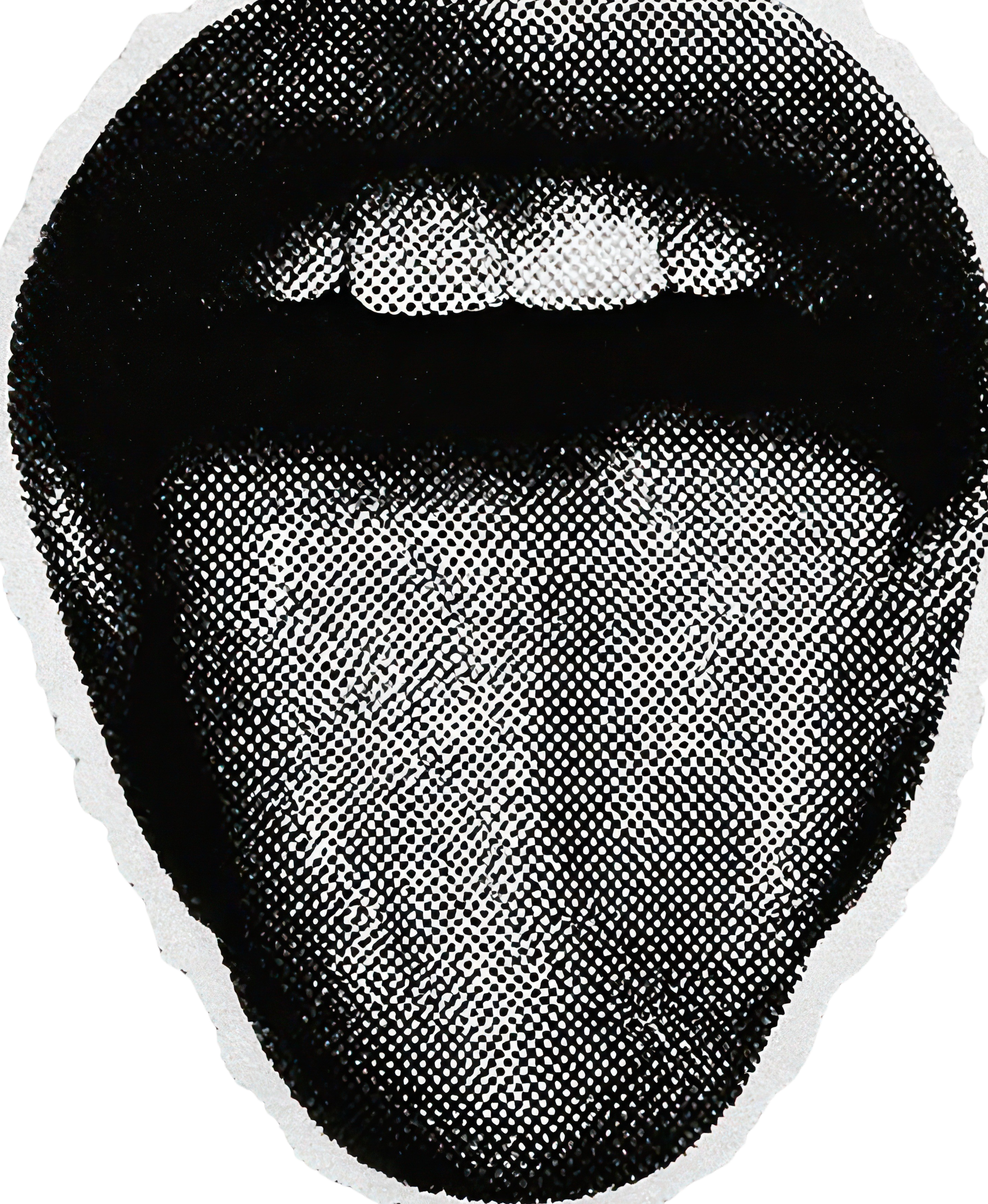 Close-up of a sticker featuring a stylized black and white face with an open mouth and tongue sticking out, created with a dot matrix pattern.
