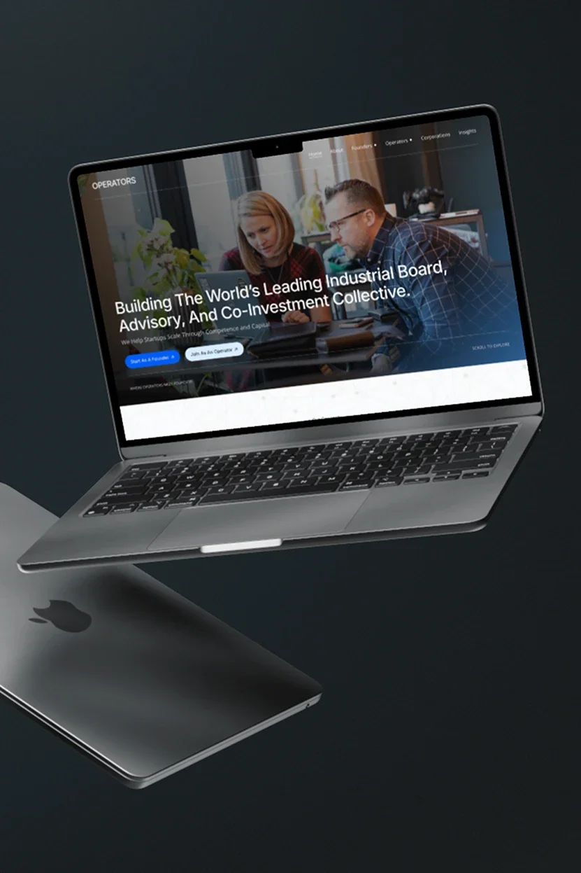 A MacBook laptop displays a website with a group of people working together. The website's headline reads "Building The World's Leading Industrial Board, Advisory, And Co-Investment Collective."