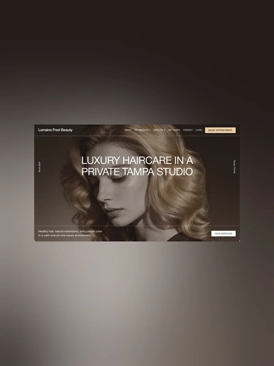 Website homepage for Lorraine Fred Beauty, a luxury haircare salon in Tampa. Features a woman with styled blonde hair and text promoting private studio services.