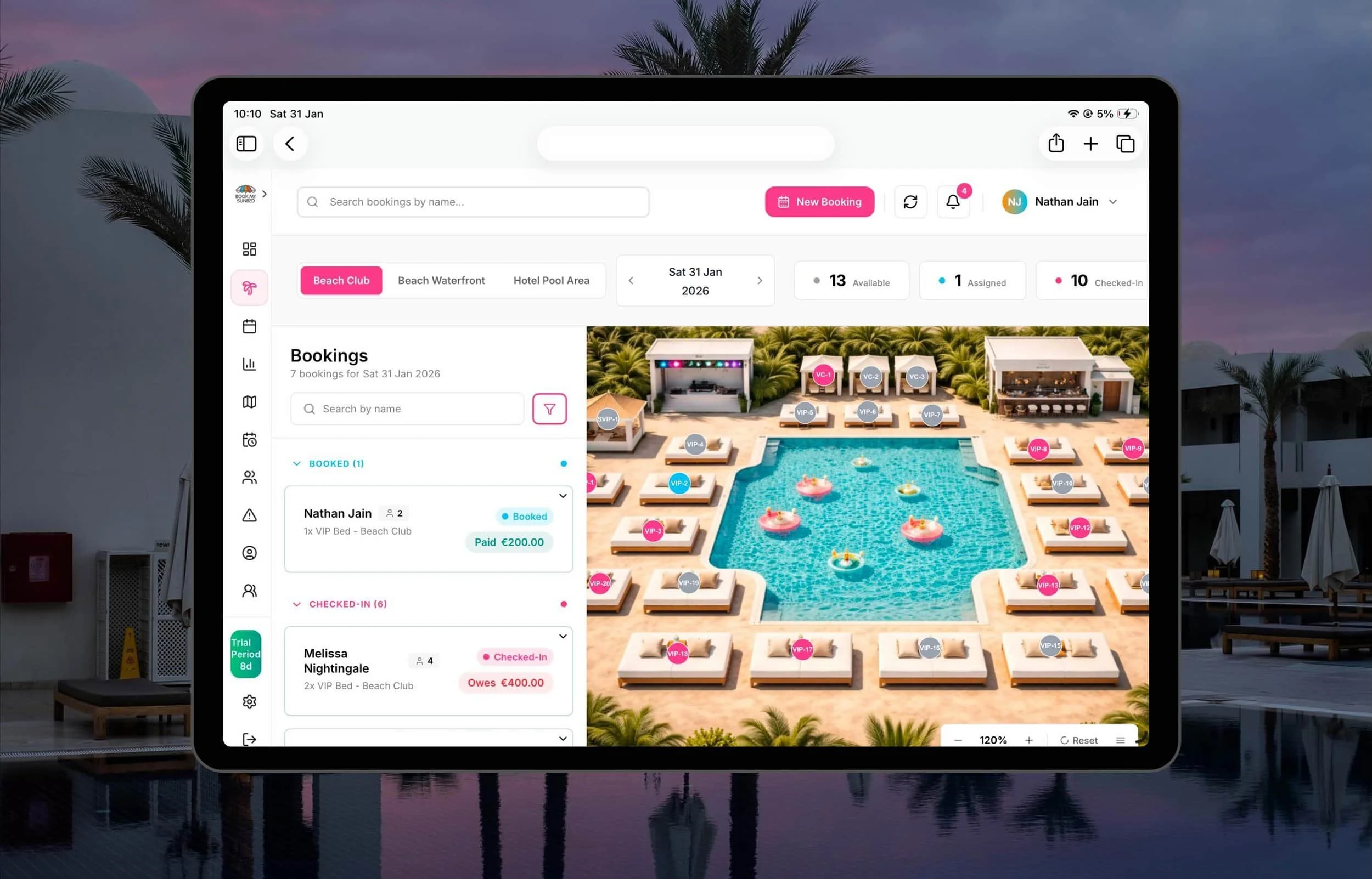 A tablet displays a Sunbed Booking System app with a poolside resort image and reservation details, set against an outdoor backdrop.