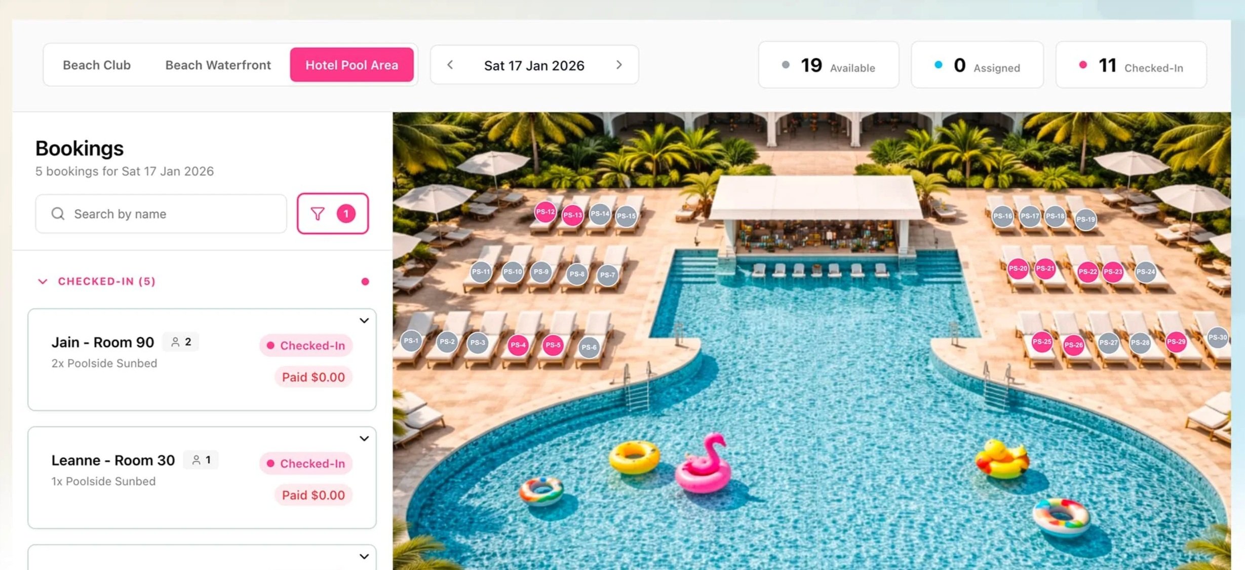 An aerial view of a hotel swimming pool area with lounge chairs, umbrellas, palm trees, and colorful pool floats. There are booking labels indicating checked-in guests.