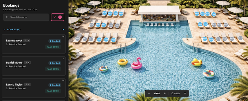 An organized poolside area with a large swimming pool surrounded by lounge chairs, umbrellas, and pool floats, viewed from above.