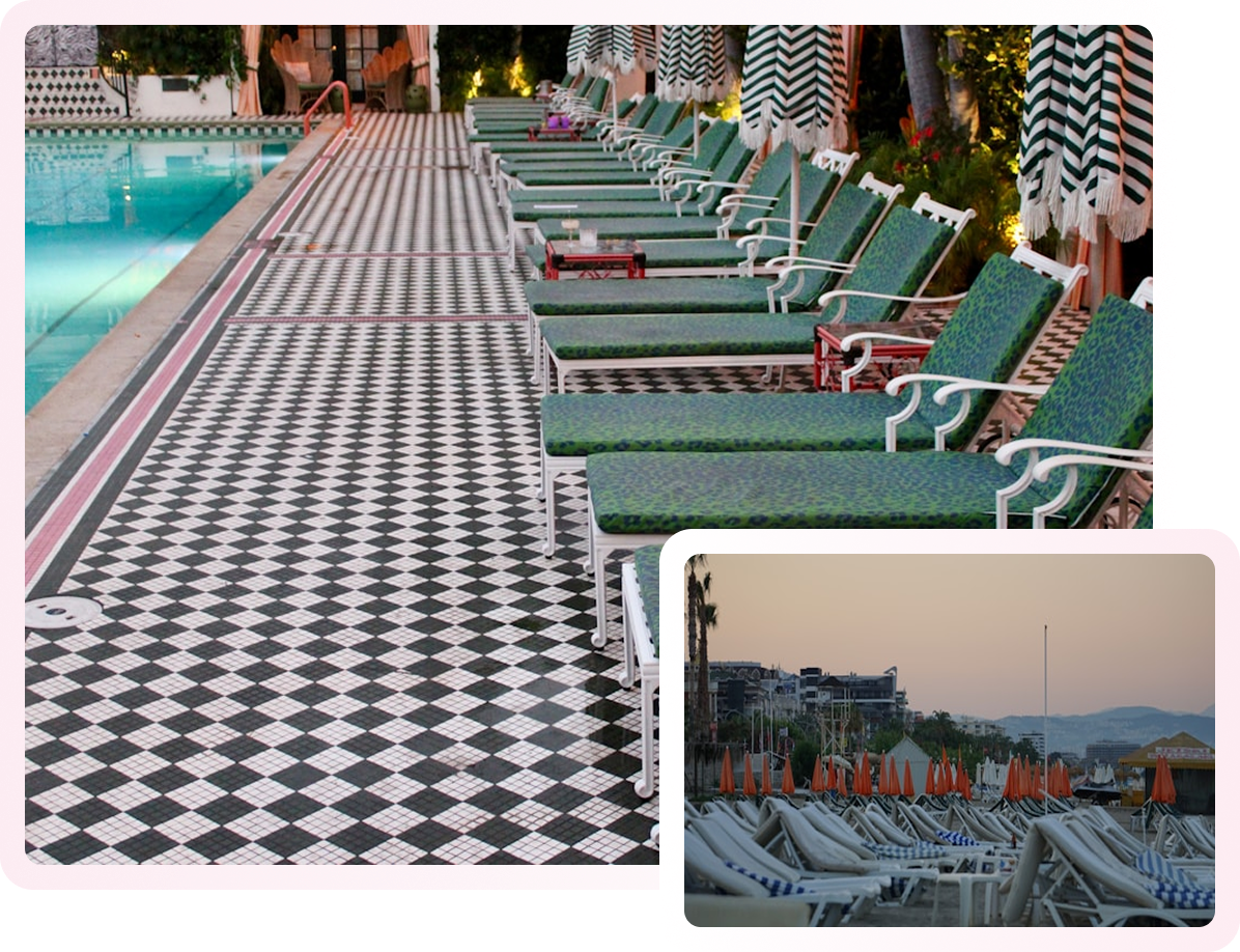 Photo of a poolside area with a black-and-white checkered tile floor, green lounge chairs, and striped umbrellas.