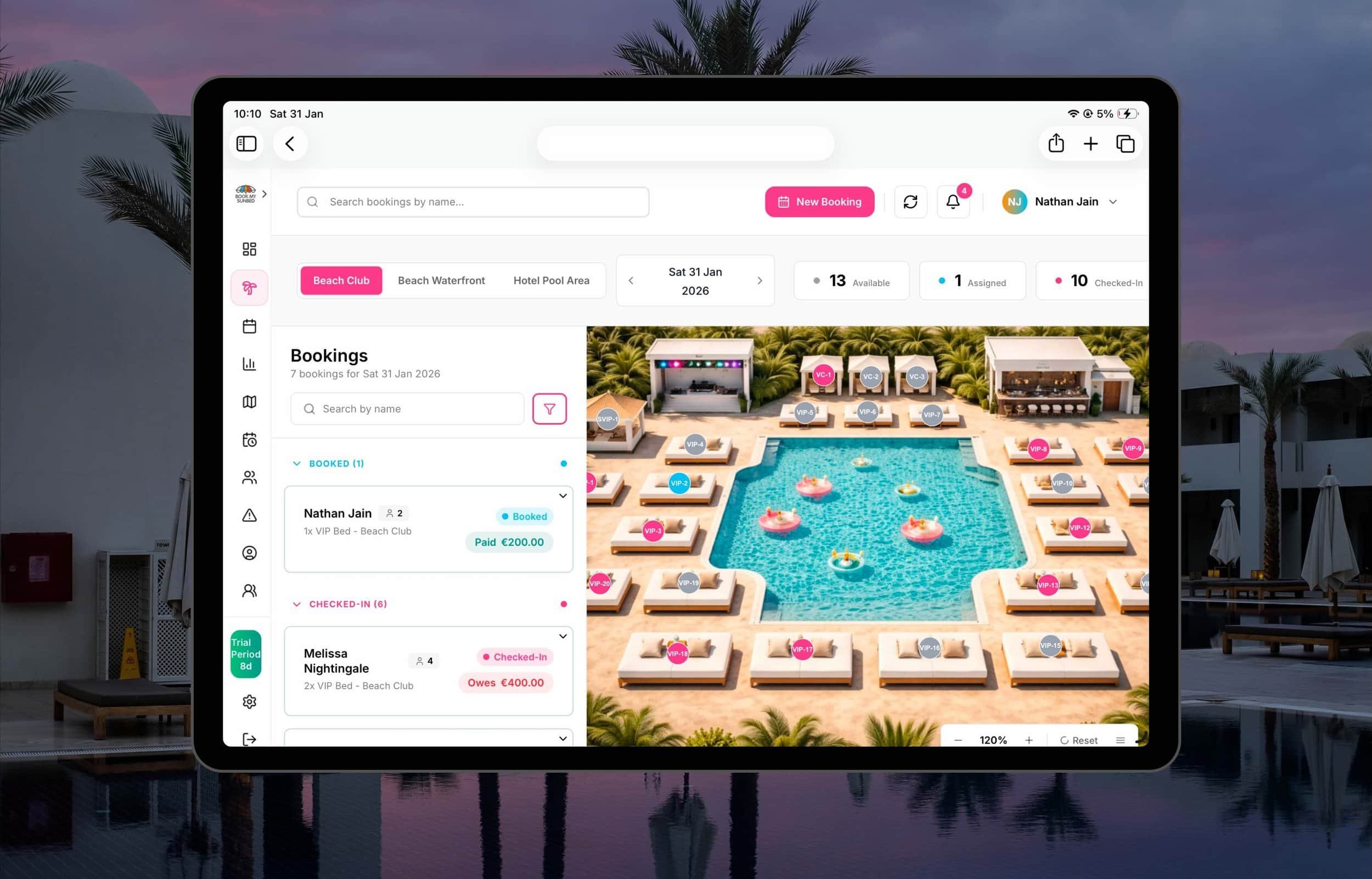 Digital interface of a booking management system against a background of a luxury pool area with sunbeds, umbrellas, palm trees, and a sunset sky.