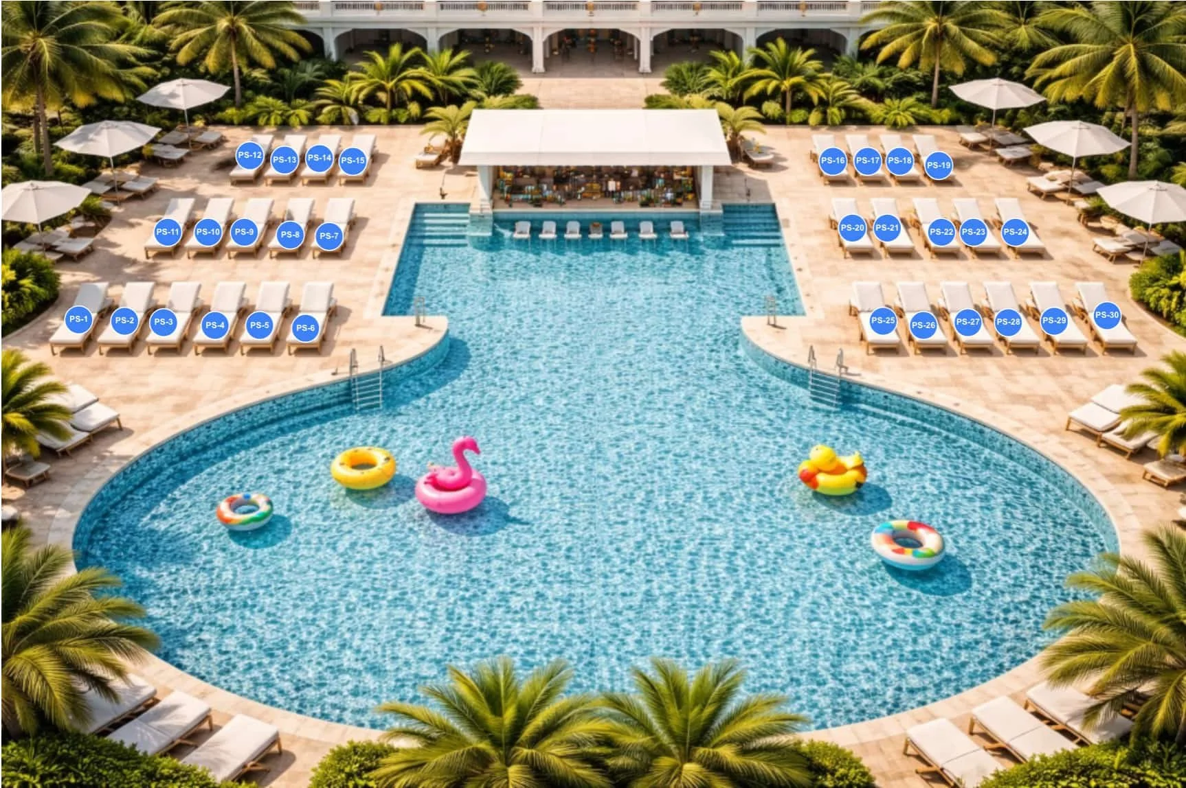 Aerial view of a large outdoor hotel swimming pool with colorful pool floats, surrounded by sun loungers and umbrellas, lush green palm trees, and a poolside bar area.