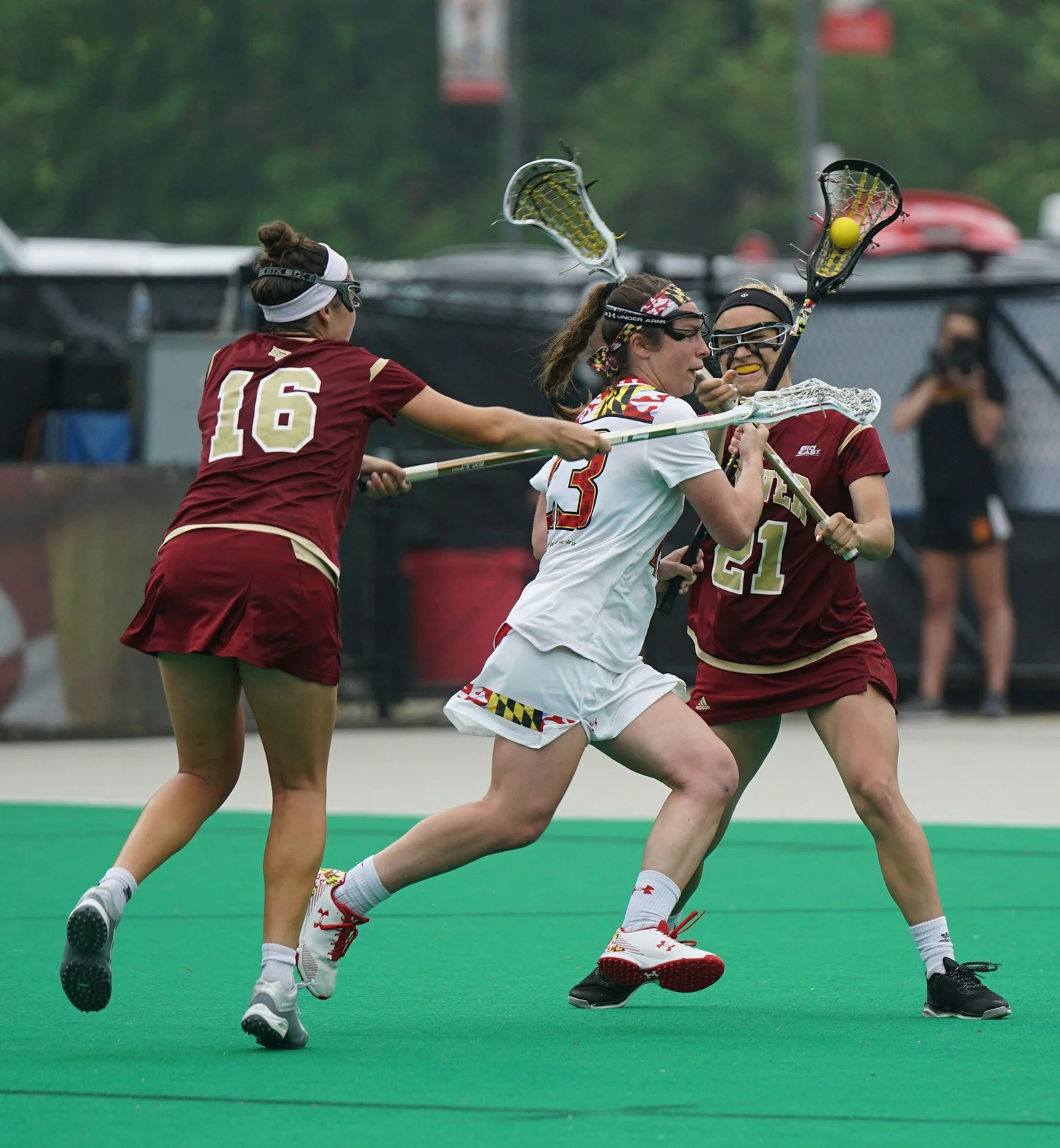 Female lacrosse athletes competing during a game