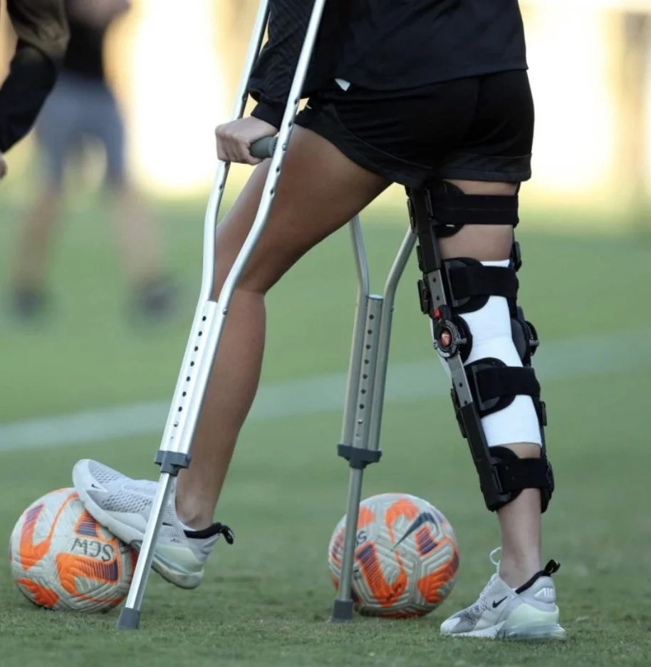 Athlete recovering from injury using crutches