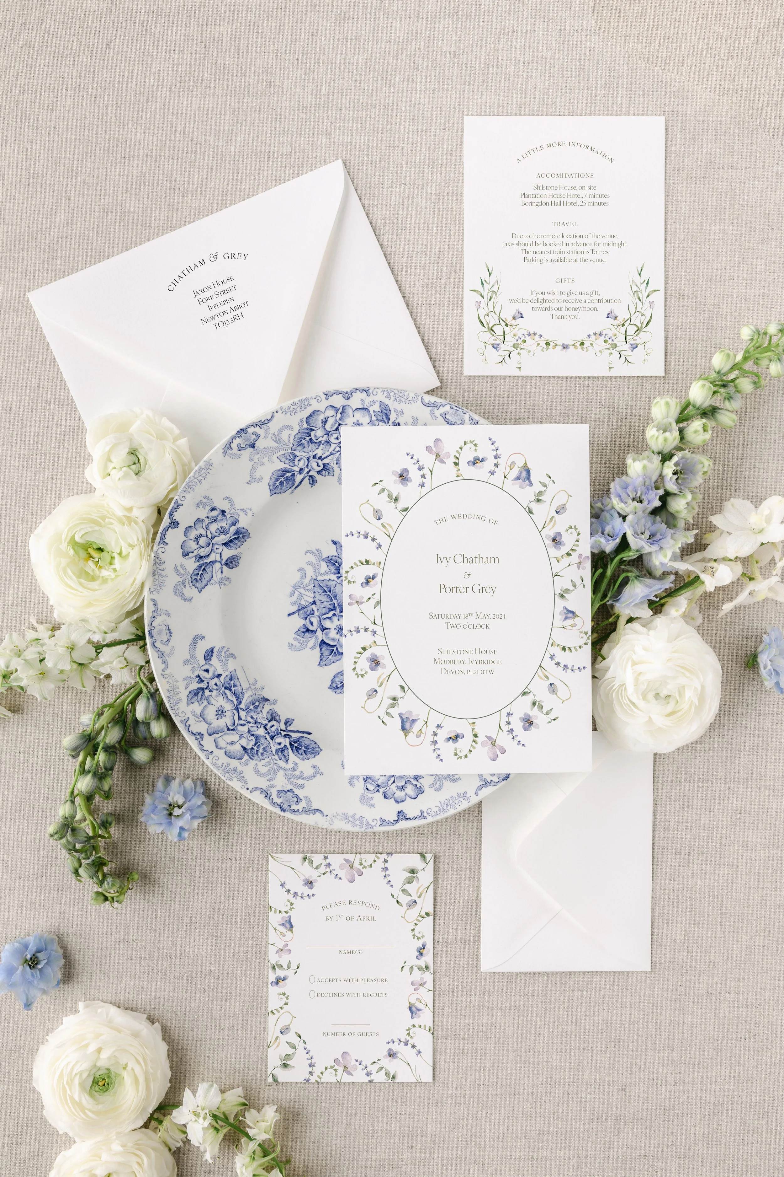 The Ivy Collection wedding suite featuring delicate blue watercolor florals, soft green vines, and an elegant serif font. Inspired by English countryside estates for a timeless, botanical feel.