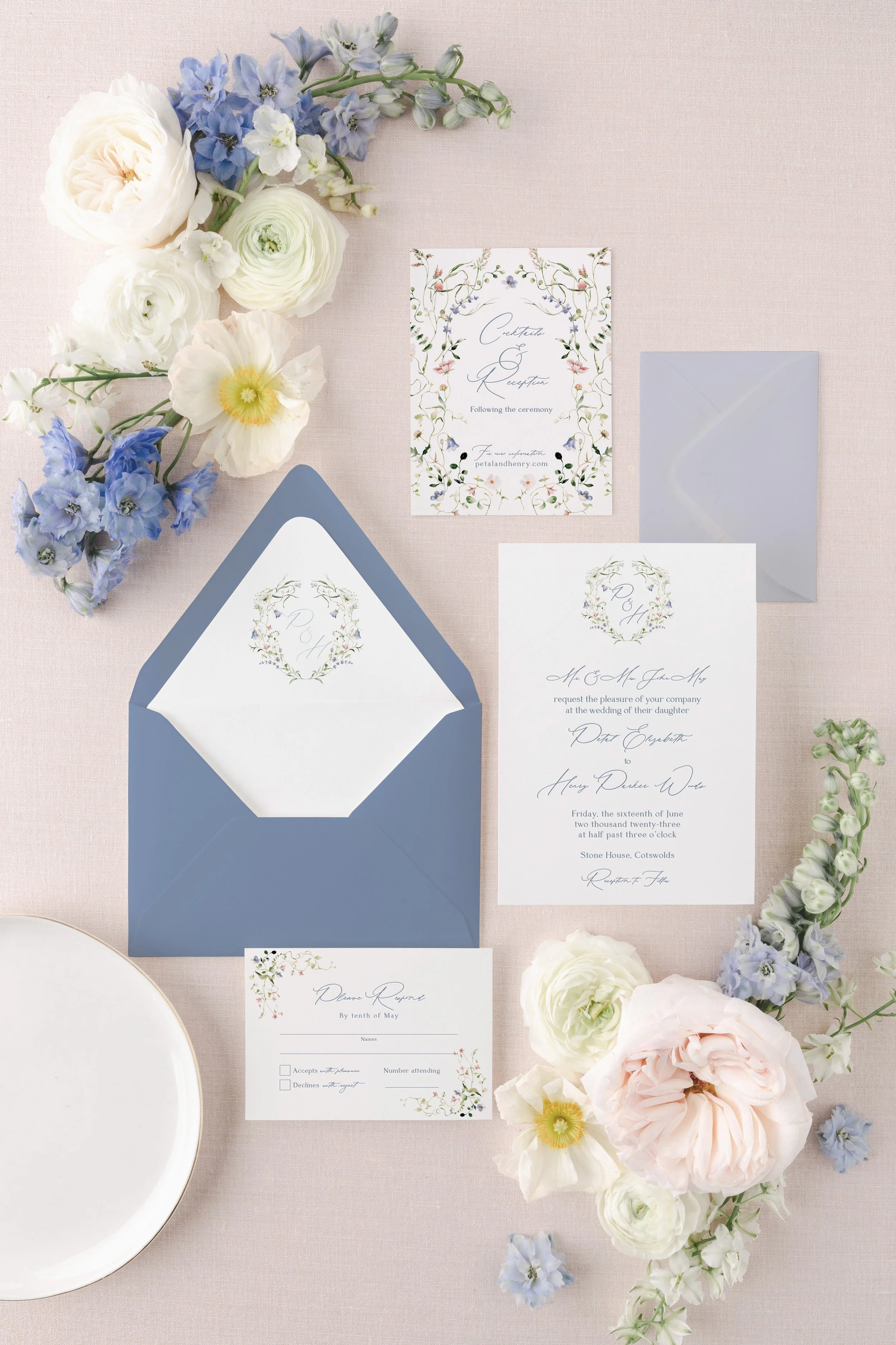 The Petal Collection wedding invitation suite featuring soft pink and blue watercolor florals, refined serif typography, and a delicate, ethereal feel.