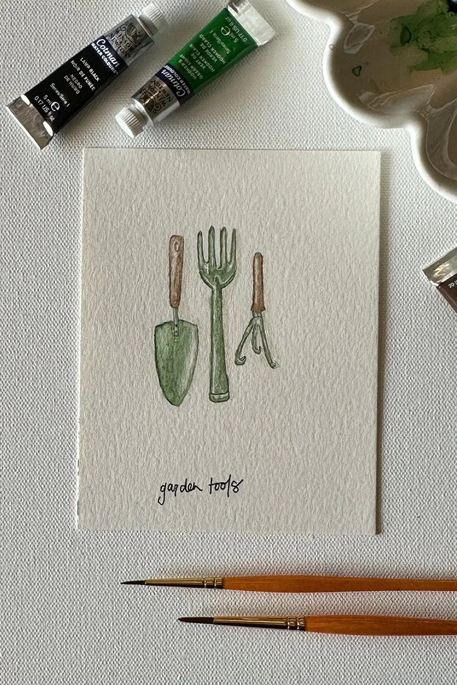 A watercolor illustration of garden tools, painted for the April garden theme.