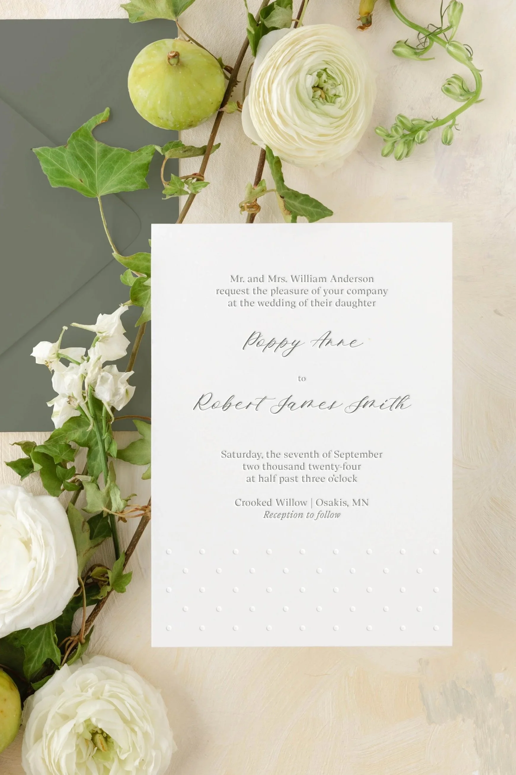 Close-up of the Poppy wedding invitation featuring refined typography and soft, tactile paper texture.